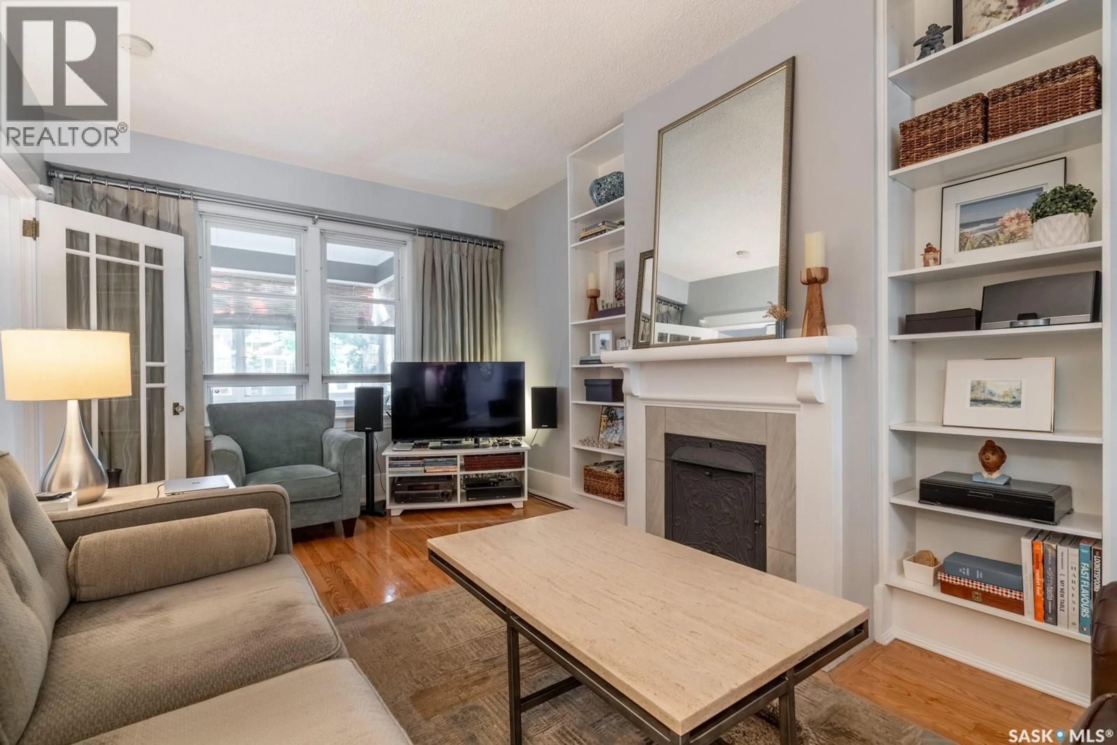 Living room with furniture, wood/laminate floor for 2321 GARNET STREET, Regina Saskatchewan S4T3A3