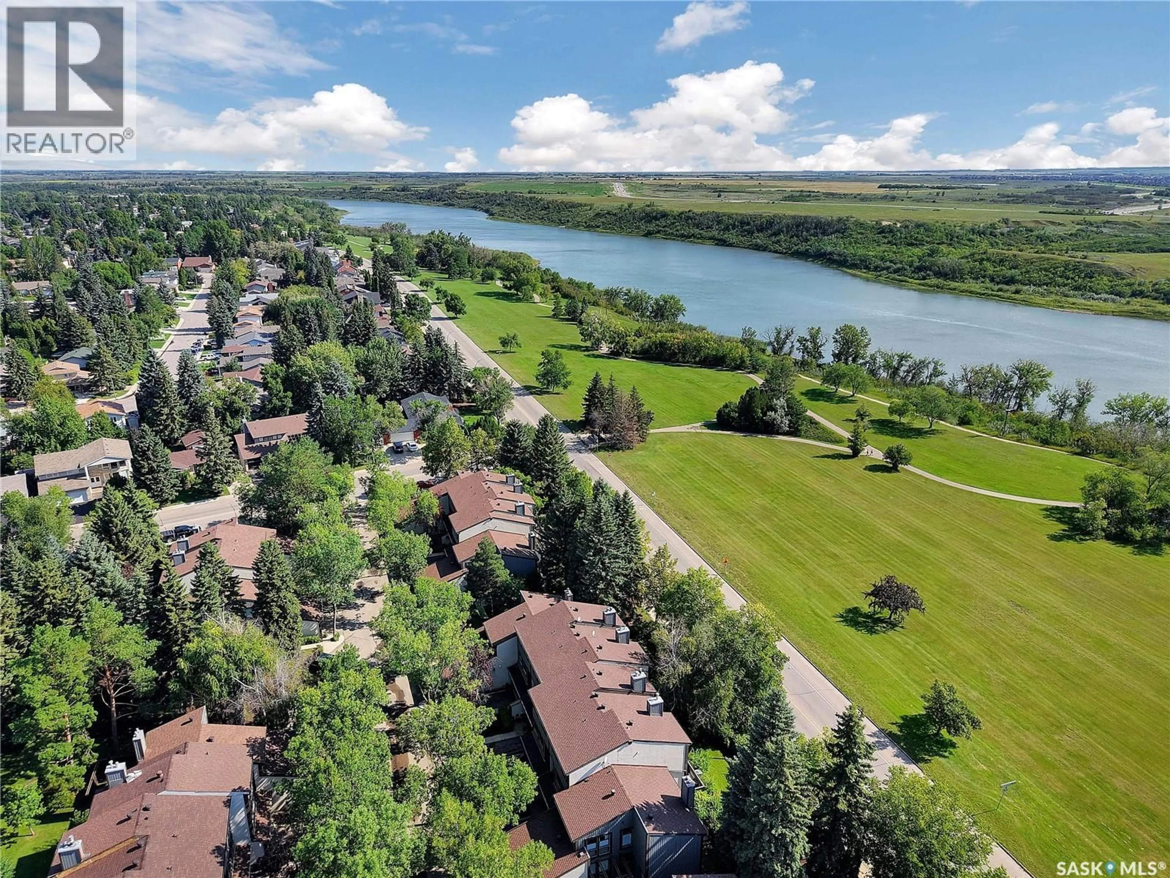 A pic from outside/outdoor area/front of a property/back of a property/a pic from drone, water/lake/river/ocean view for 12 455 PINEHOUSE DRIVE, Saskatoon Saskatchewan S7K5X1