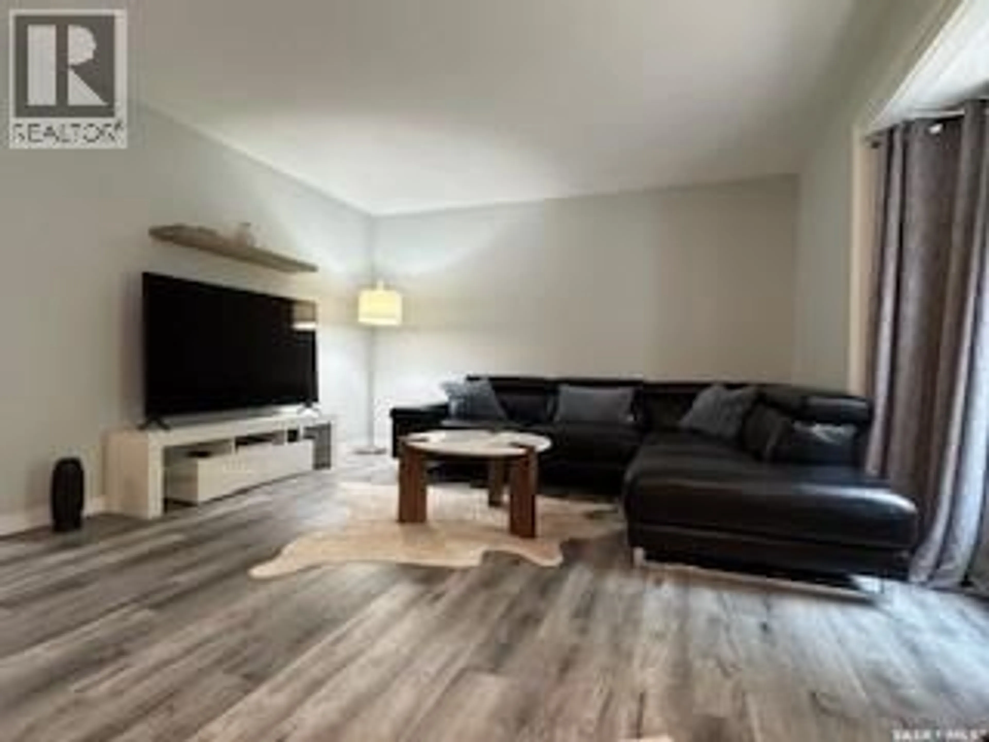 Living room with furniture, wood/laminate floor for 3107 7TH AVENUE, Regina Saskatchewan S4N5G1