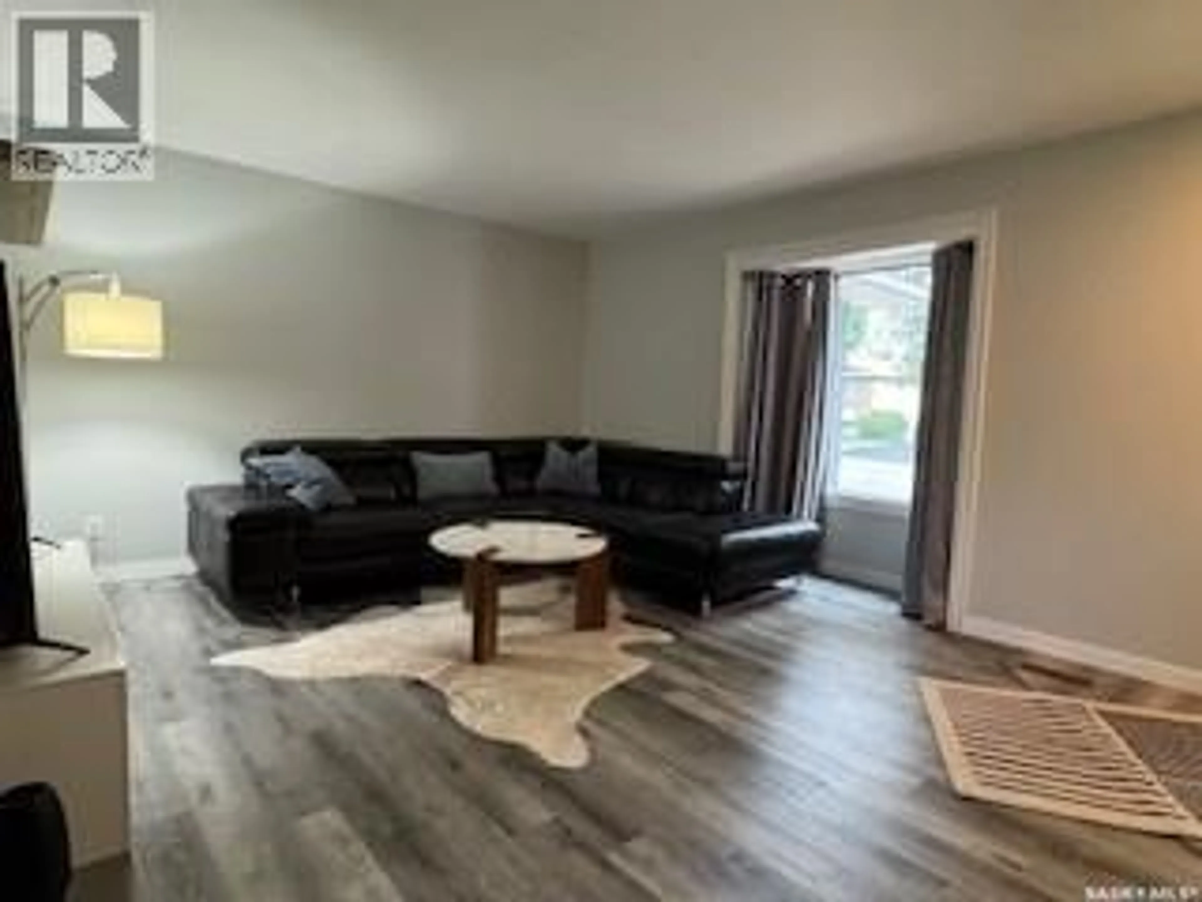Living room with furniture, wood/laminate floor for 3107 7TH AVENUE, Regina Saskatchewan S4N5G1