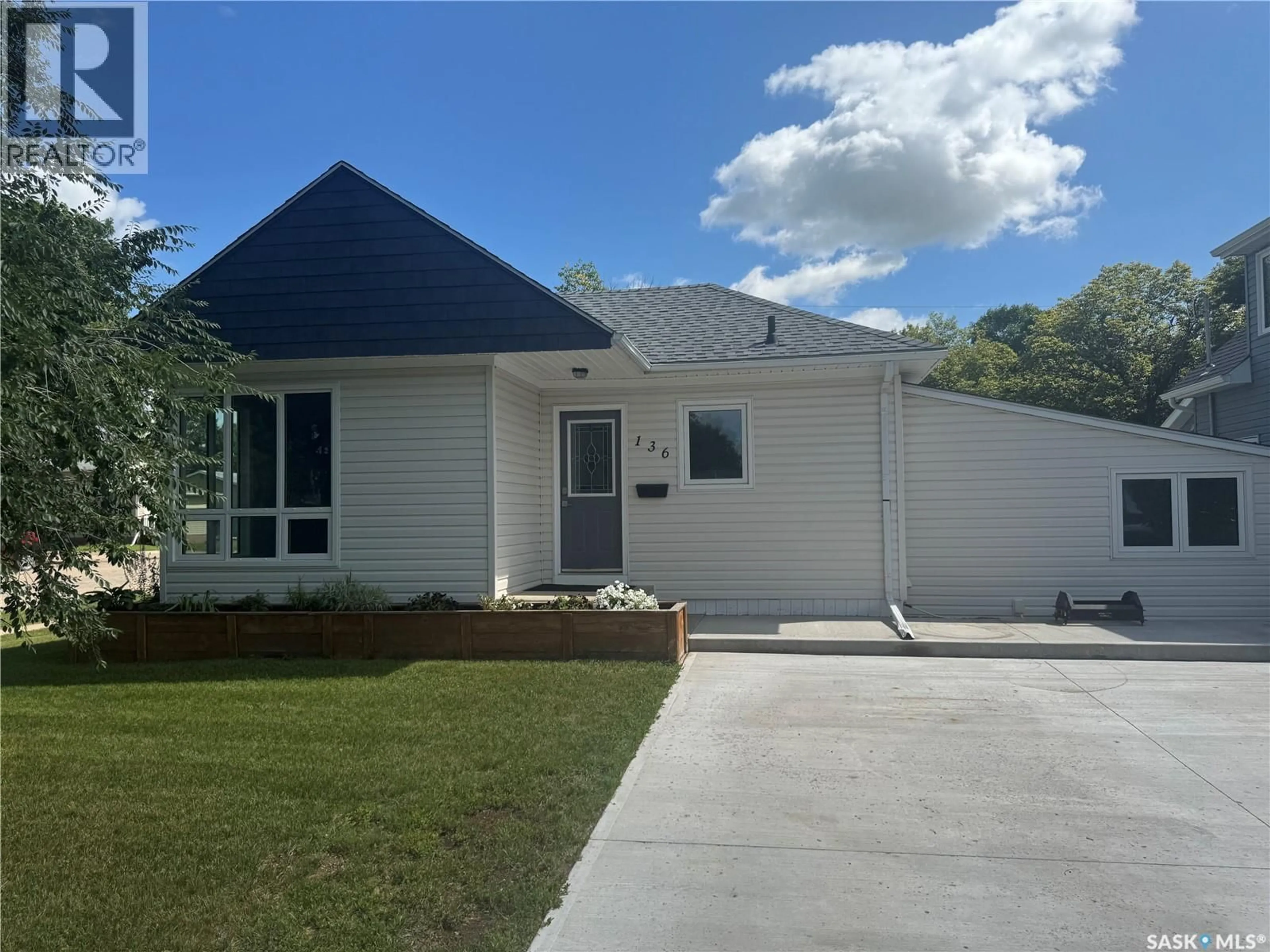 Home with vinyl exterior material, street for 136 10TH STREET, Weyburn Saskatchewan S4H1G9