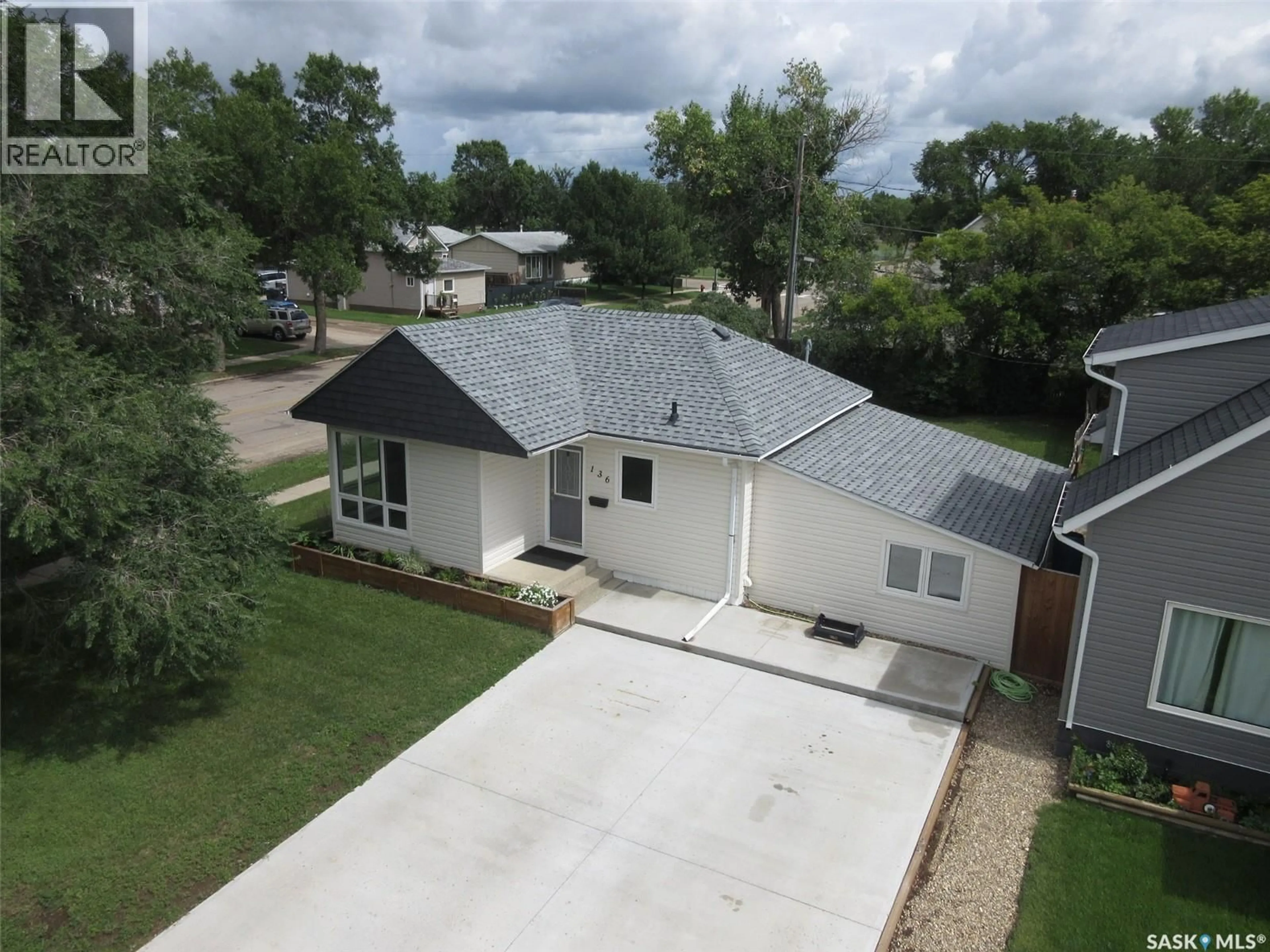 A pic from outside/outdoor area/front of a property/back of a property/a pic from drone, street for 136 10TH STREET, Weyburn Saskatchewan S4H1G9