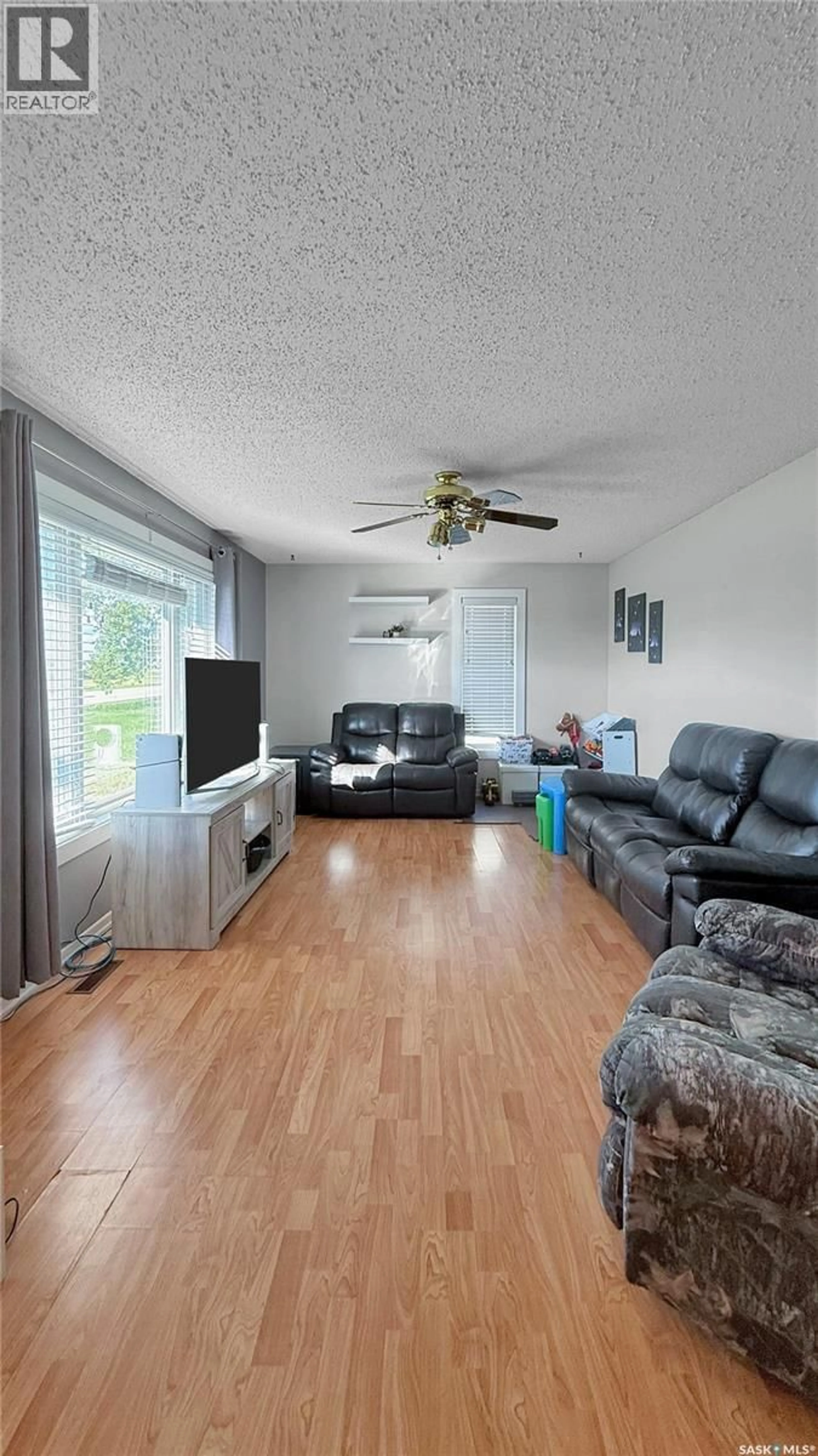 Living room with furniture, wood/laminate floor for 405 LINCOLN AVENUE, Hanley Saskatchewan S0G2E0