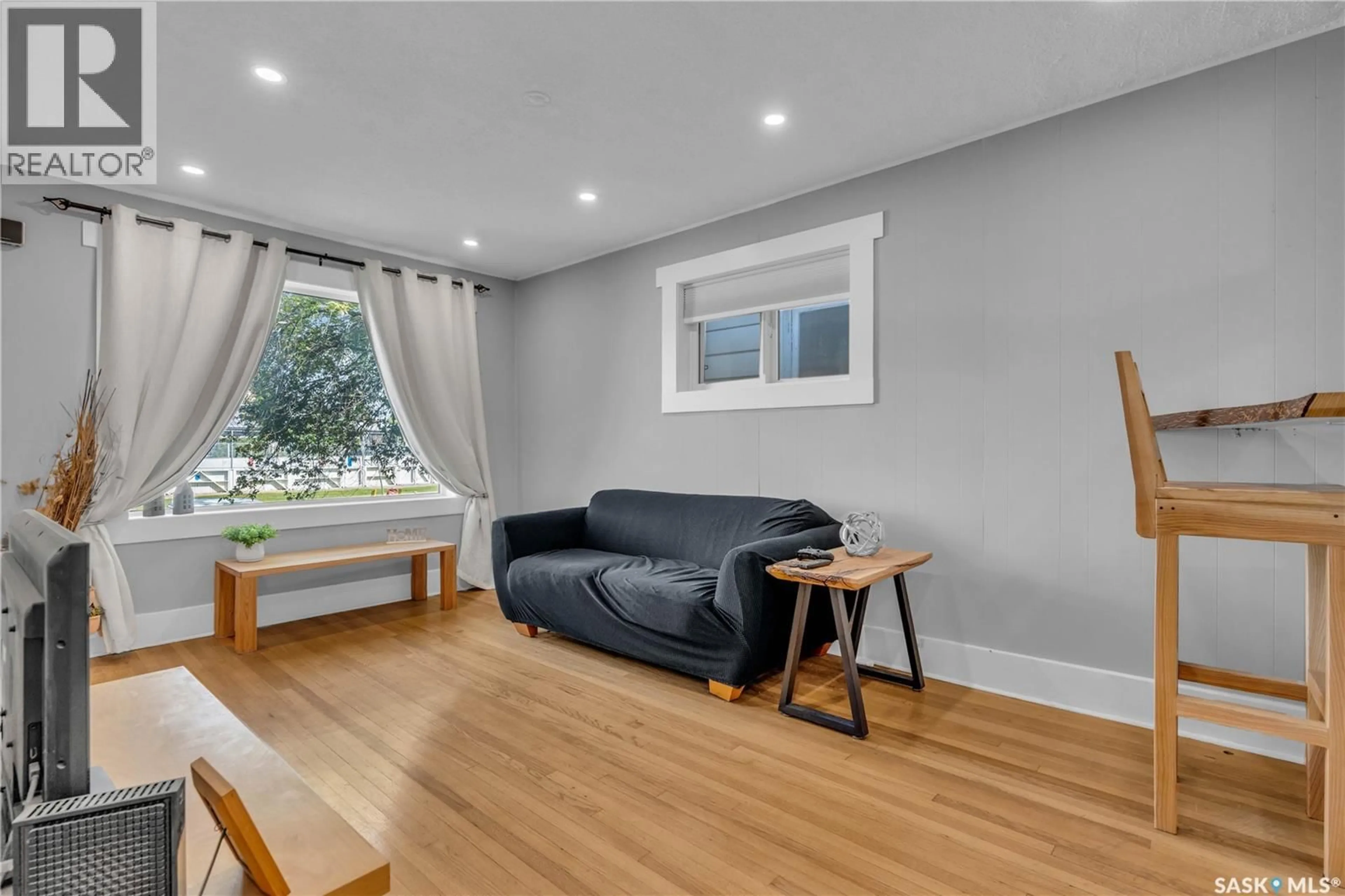 Living room with furniture, wood/laminate floor for 2212 EDGAR STREET, Regina Saskatchewan S4N3K9