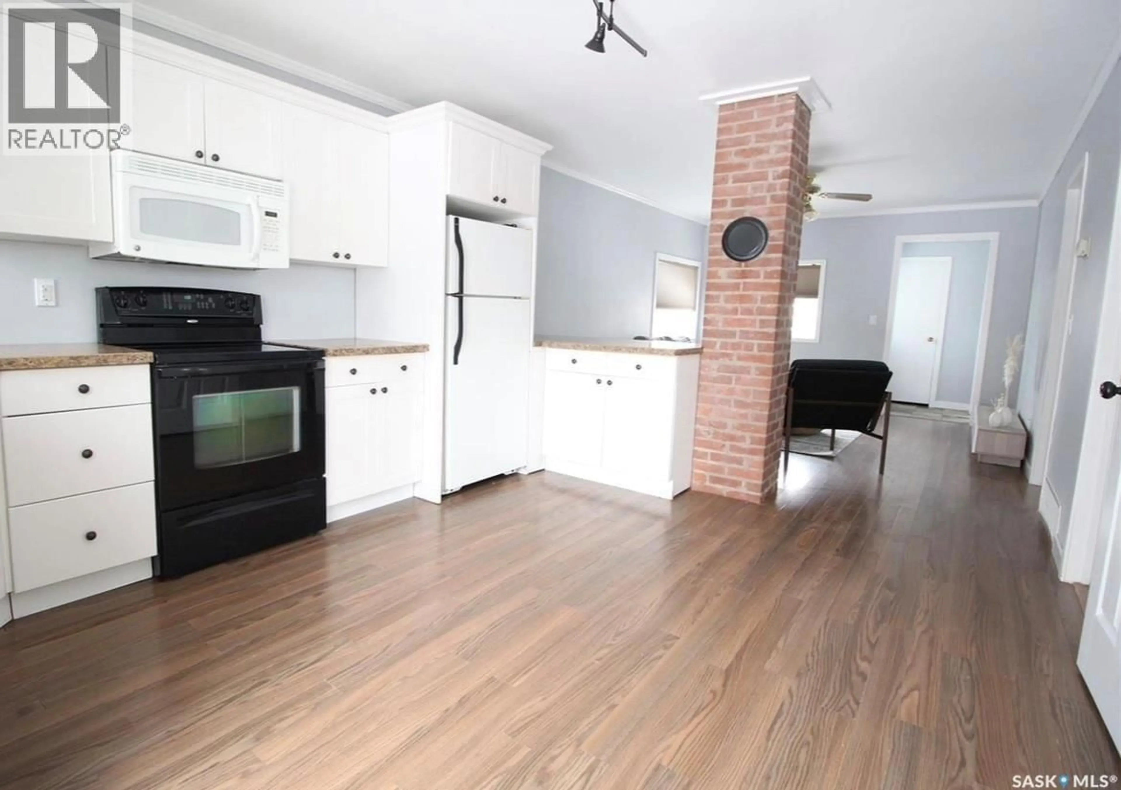 Open concept kitchen, wood/laminate floor for 111 PIPESTONE AVENUE, Wawota Saskatchewan S0G5A0