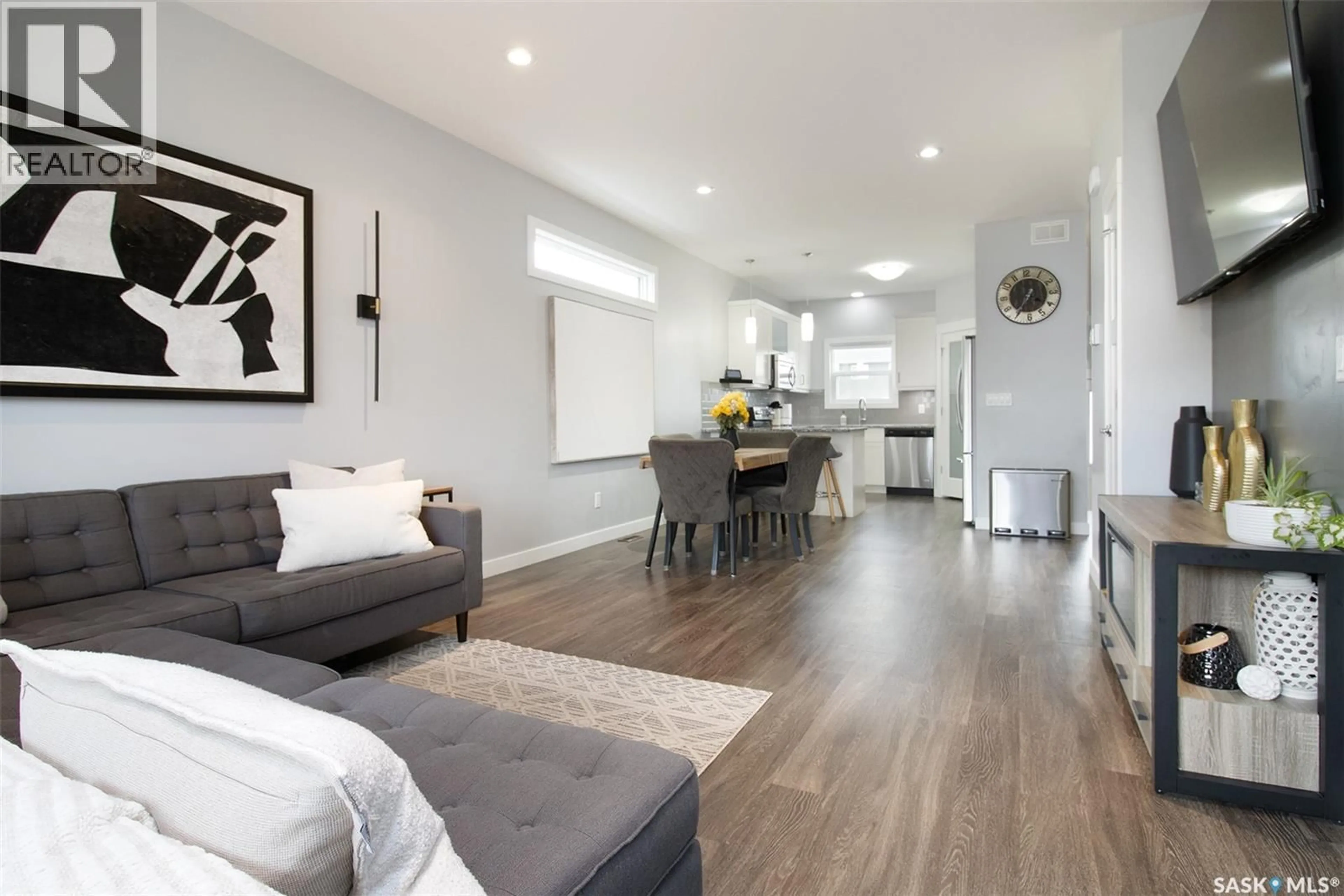 Living room with furniture, wood/laminate floor for 4834 GREEN ROCK ROAD, Regina Saskatchewan S4V3L1