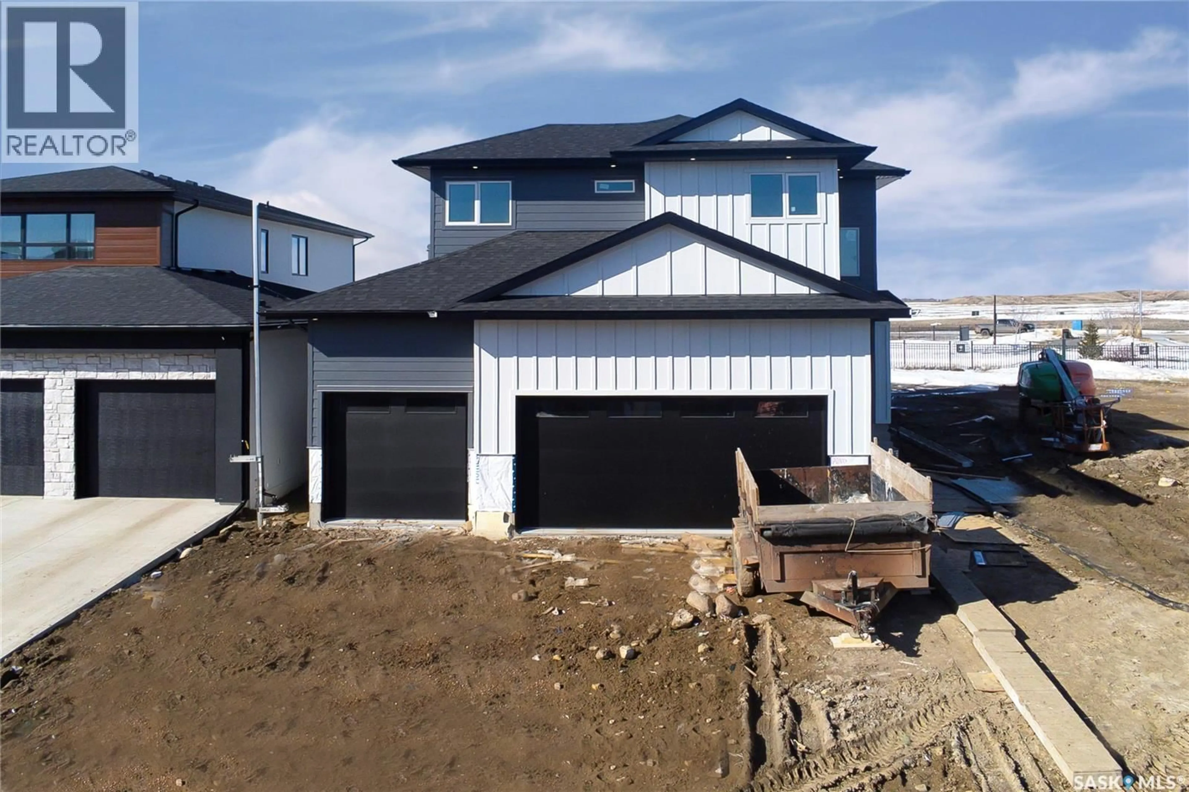 Home with vinyl exterior material, street for 447 WOOLF BEND, Saskatoon Saskatchewan S7W1E6