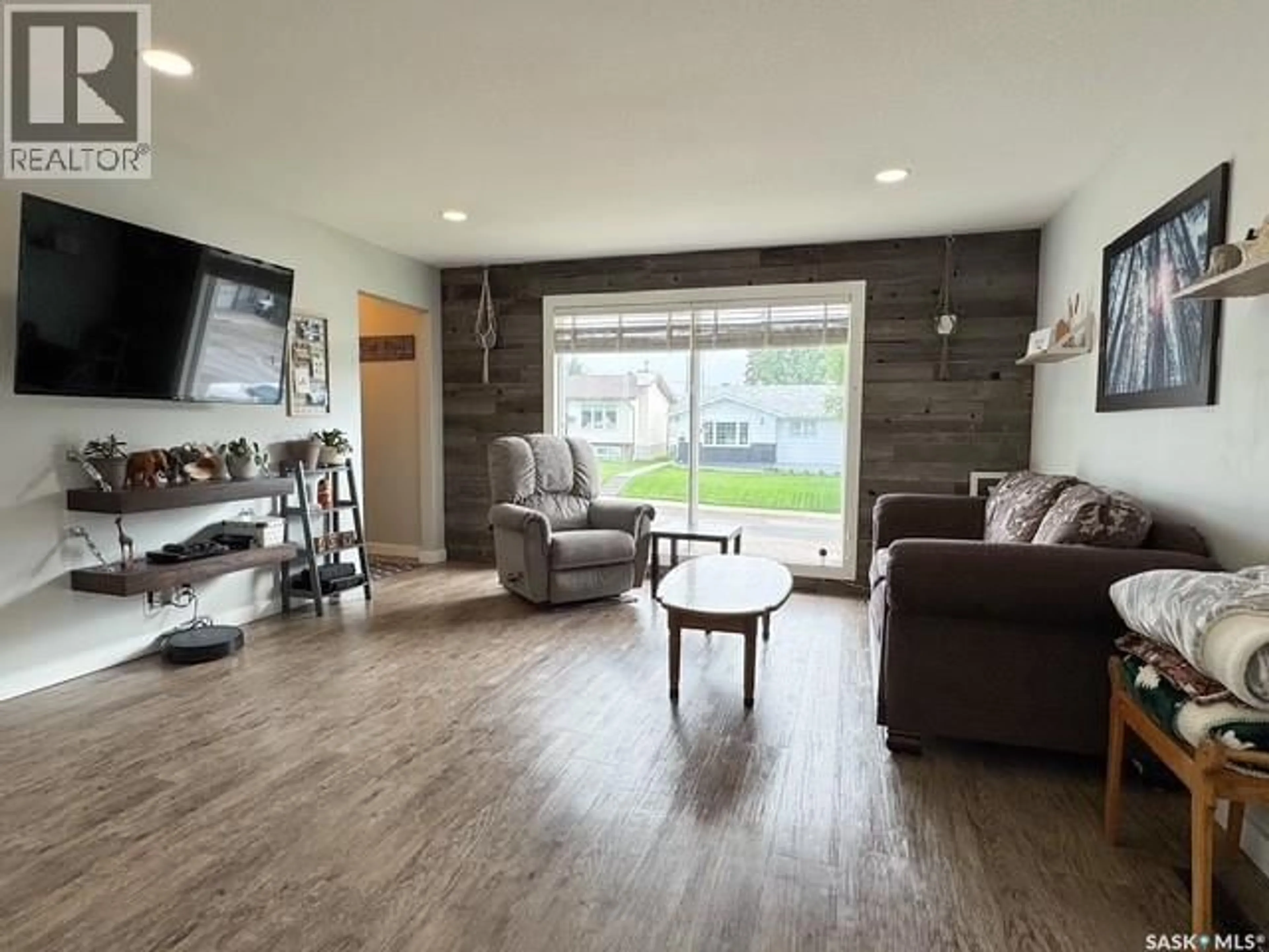 Living room with furniture, wood/laminate floor for 1113 BELL STREET, Swift Current Saskatchewan S9H1S3