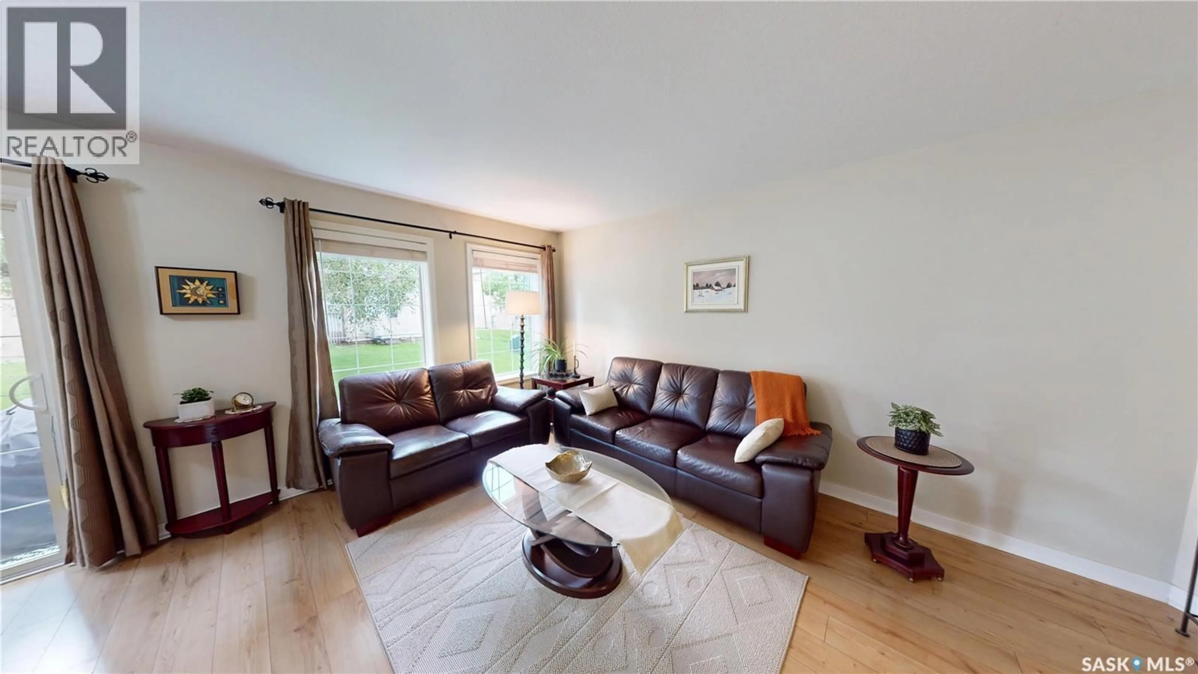 Living room with furniture, wood/laminate floor for 31 127 BANYAN CRESCENT, Saskatoon Saskatchewan S7V1G5
