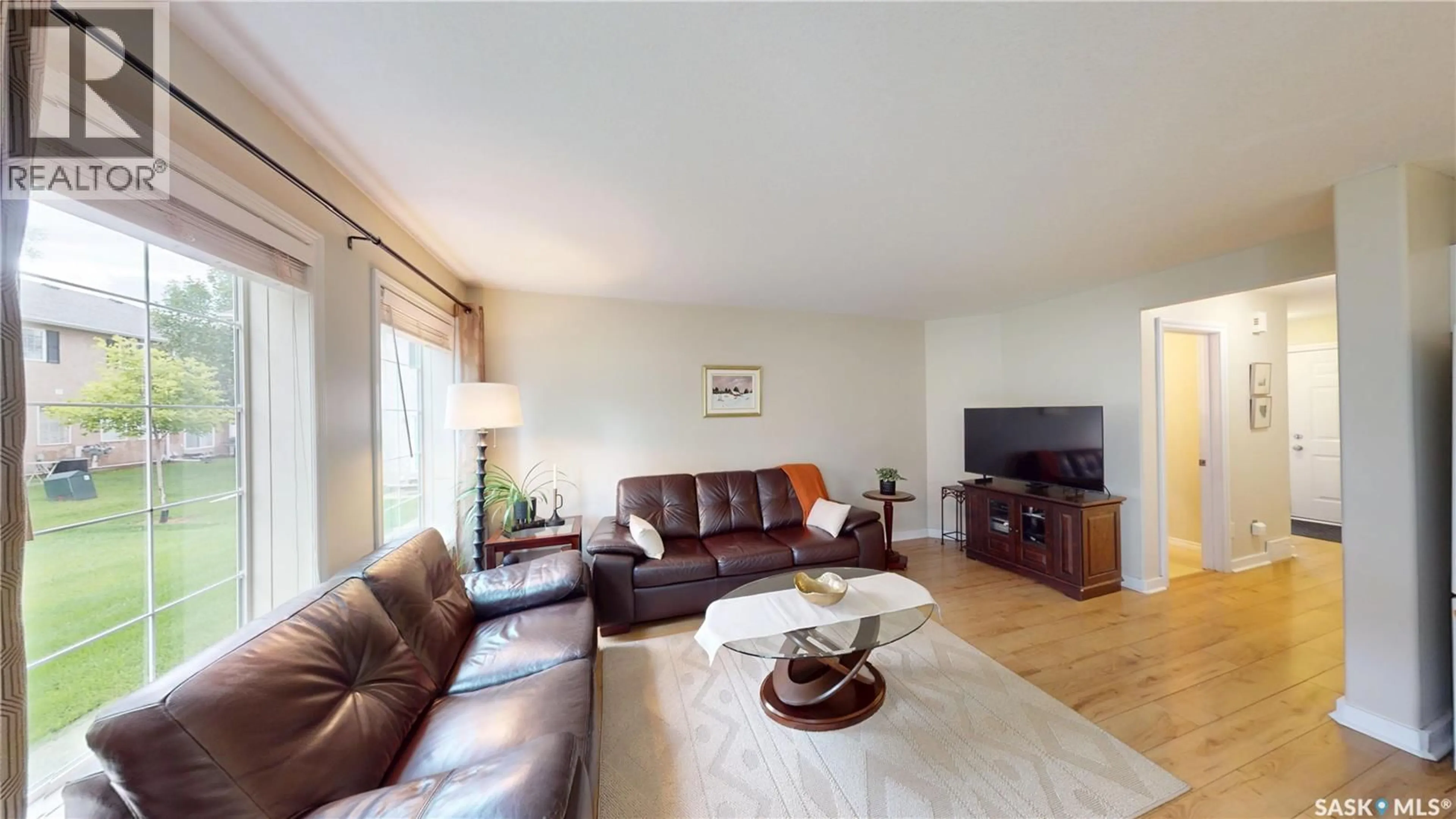 Living room with furniture, wood/laminate floor for 31 127 BANYAN CRESCENT, Saskatoon Saskatchewan S7V1G5