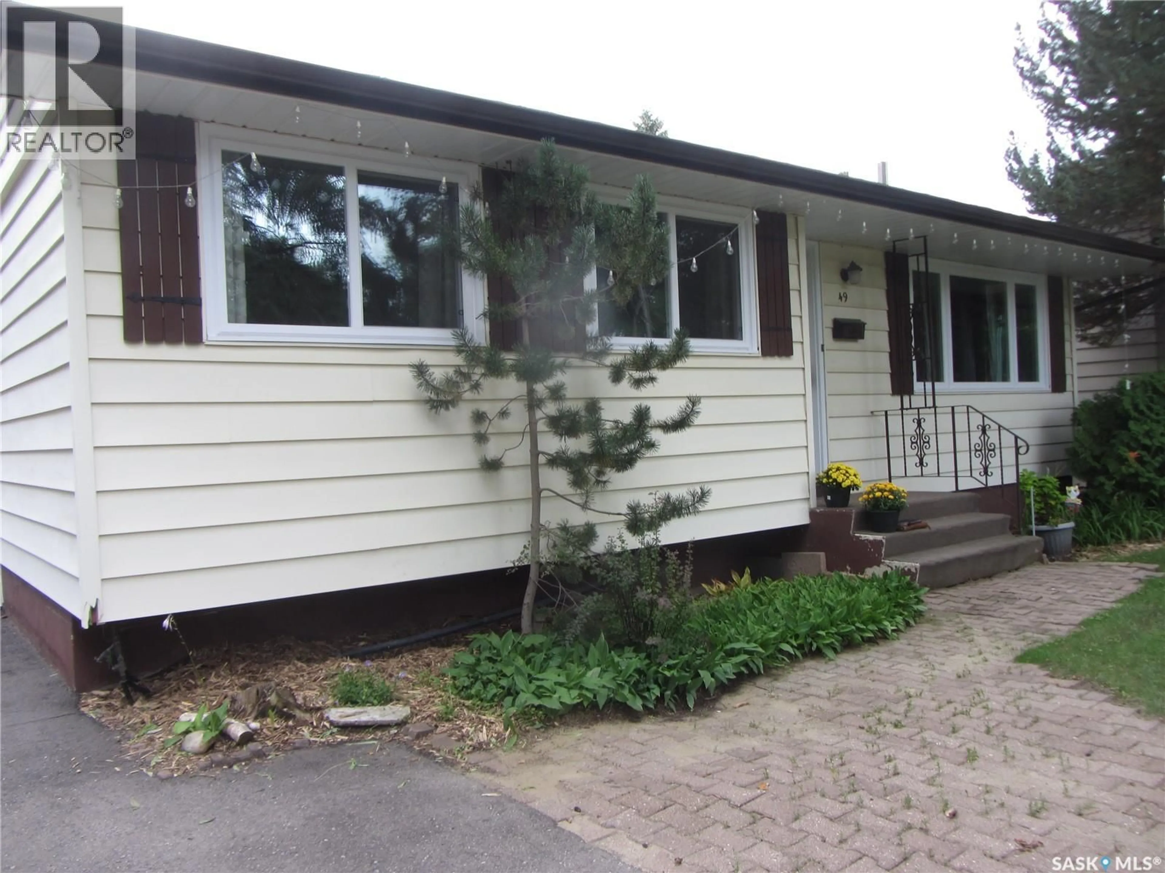 Home with vinyl exterior material, street for 49 MCLELLAN AVENUE, Saskatoon Saskatchewan S7H3K7