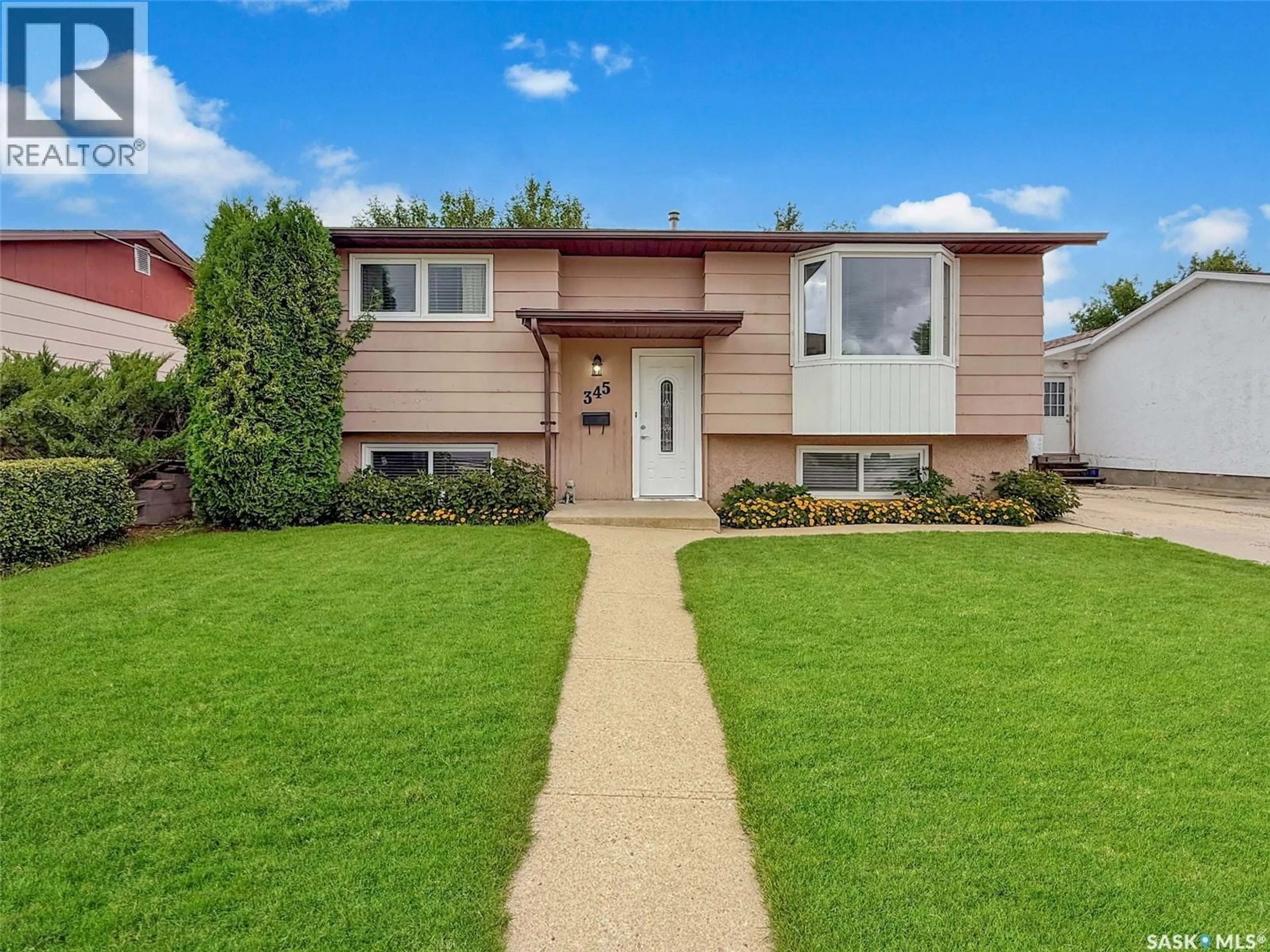 Home with vinyl exterior material, street for 345 ASPEN DRIVE, Swift Current Saskatchewan S9H3Z8