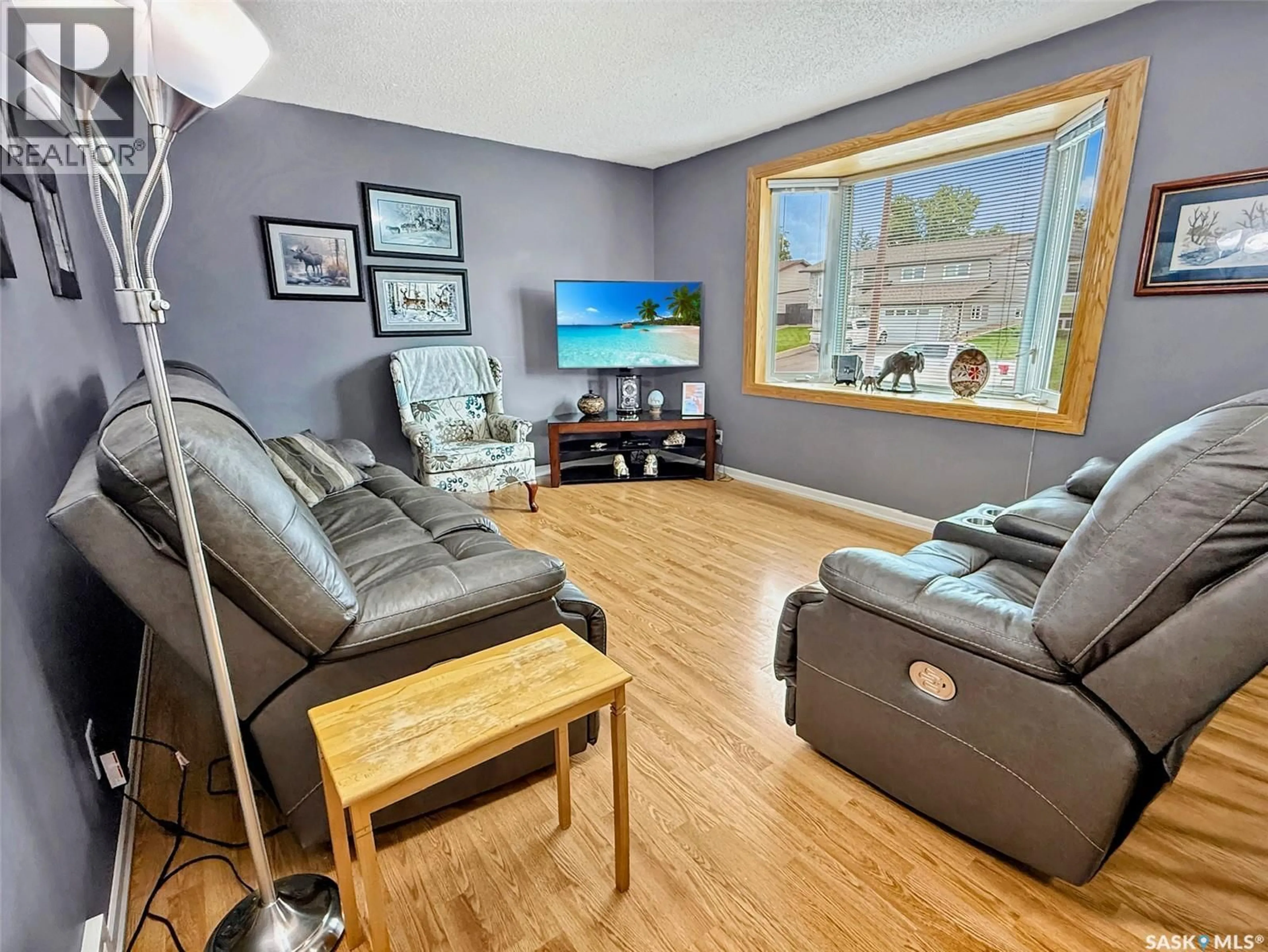 Living room with furniture, wood/laminate floor for 345 ASPEN DRIVE, Swift Current Saskatchewan S9H3Z8