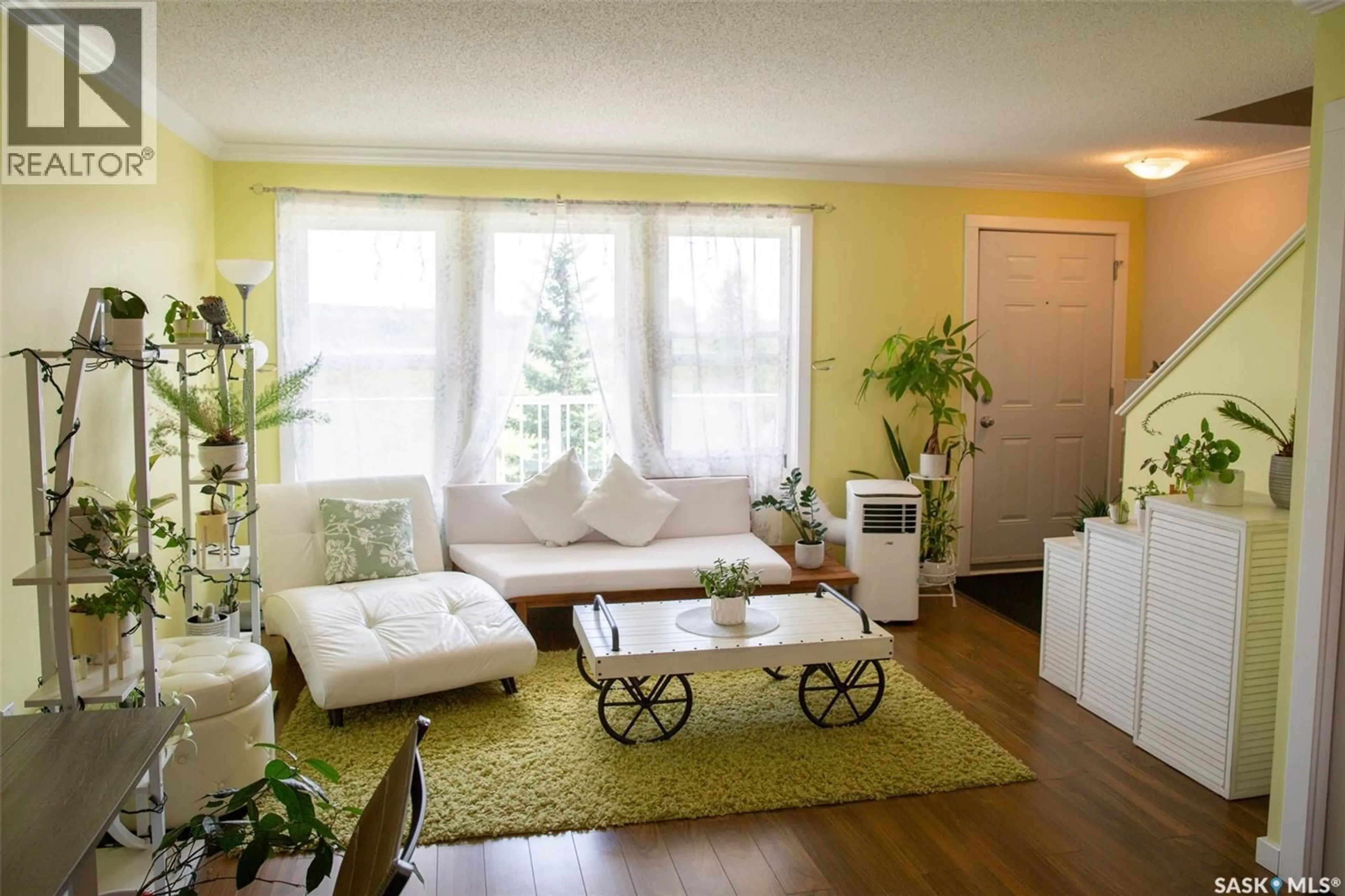 Living room with furniture, wood/laminate floor for 315 - 223 HAMPTON CIRCLE, Saskatoon Saskatchewan S7R0J7