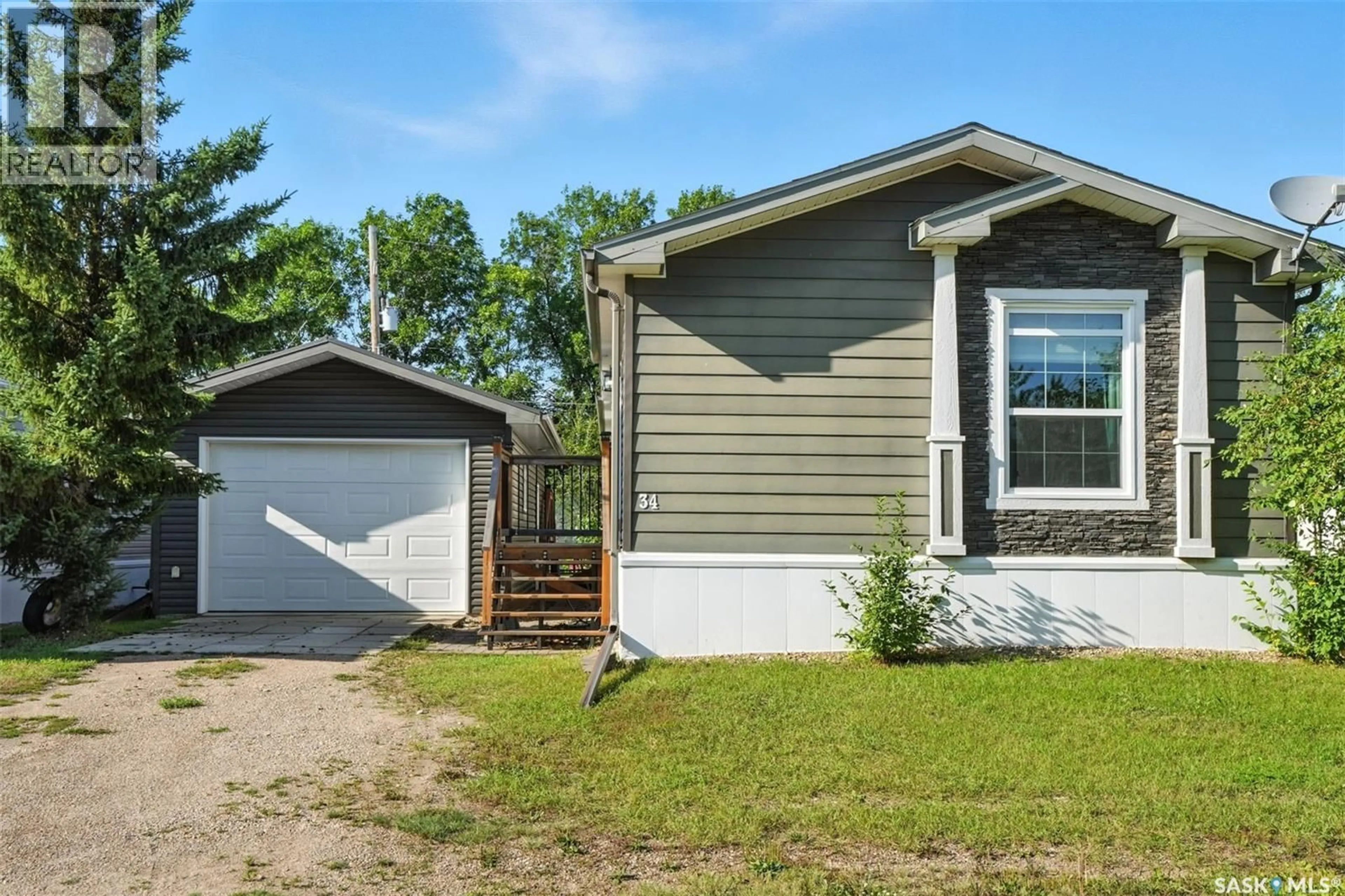 Home with vinyl exterior material, street for 34 TRILAND TRAILER COURT, Lanigan Saskatchewan S0K2M0