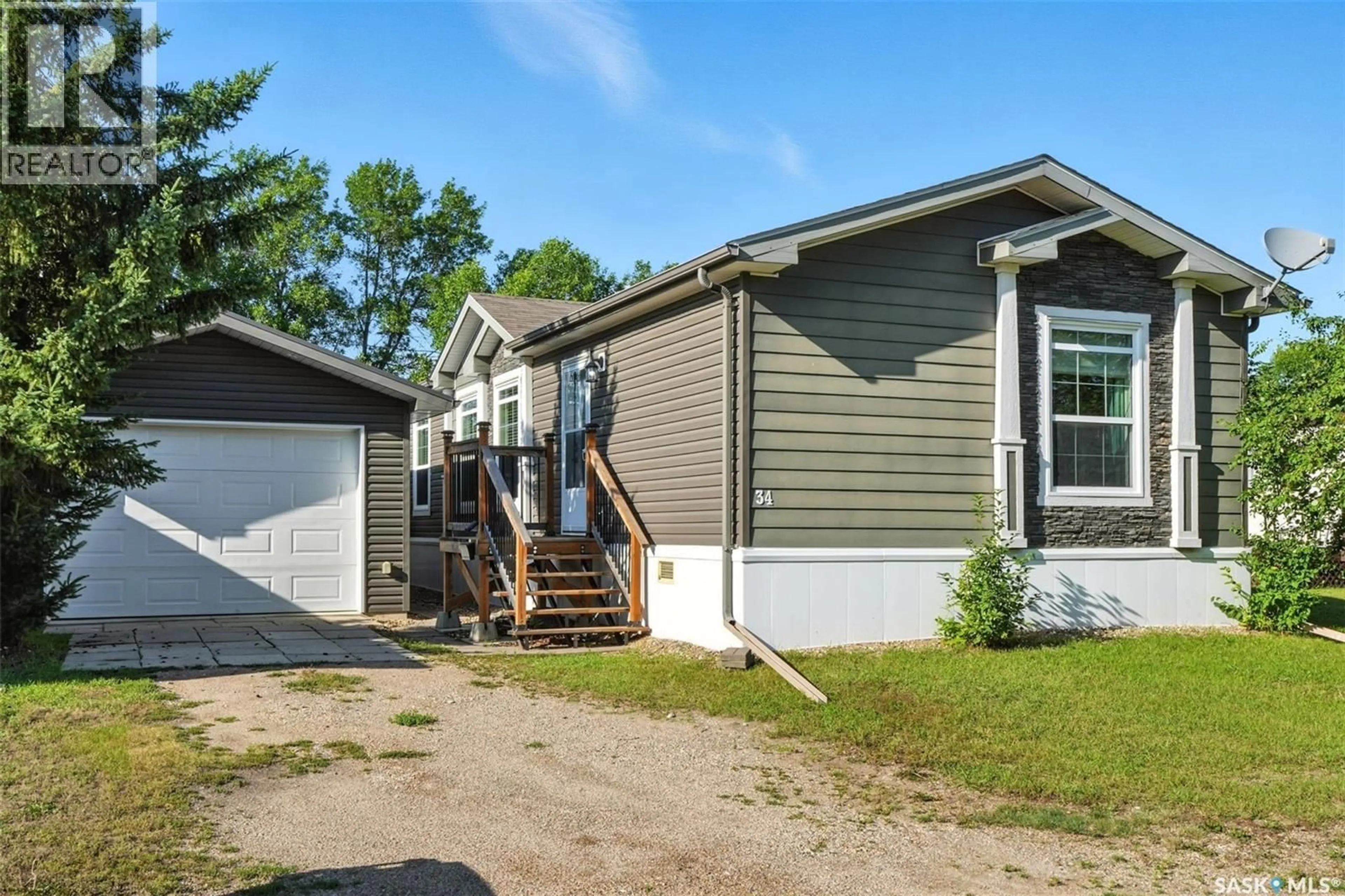 Home with vinyl exterior material, street for 34 TRILAND TRAILER COURT, Lanigan Saskatchewan S0K2M0