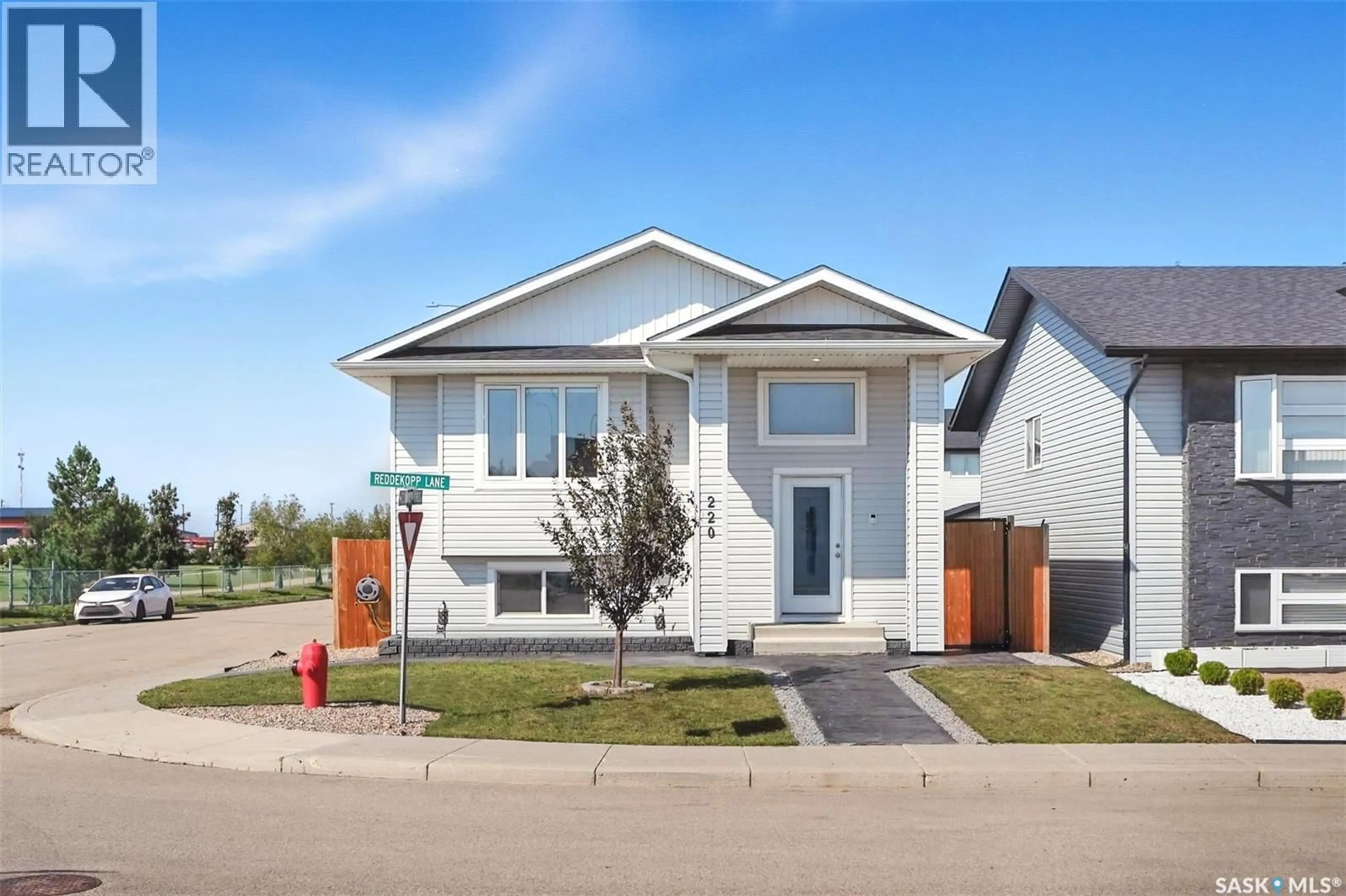 Home with vinyl exterior material, street for 220 REDDEKOPP LANE, Warman Saskatchewan S0K4S3