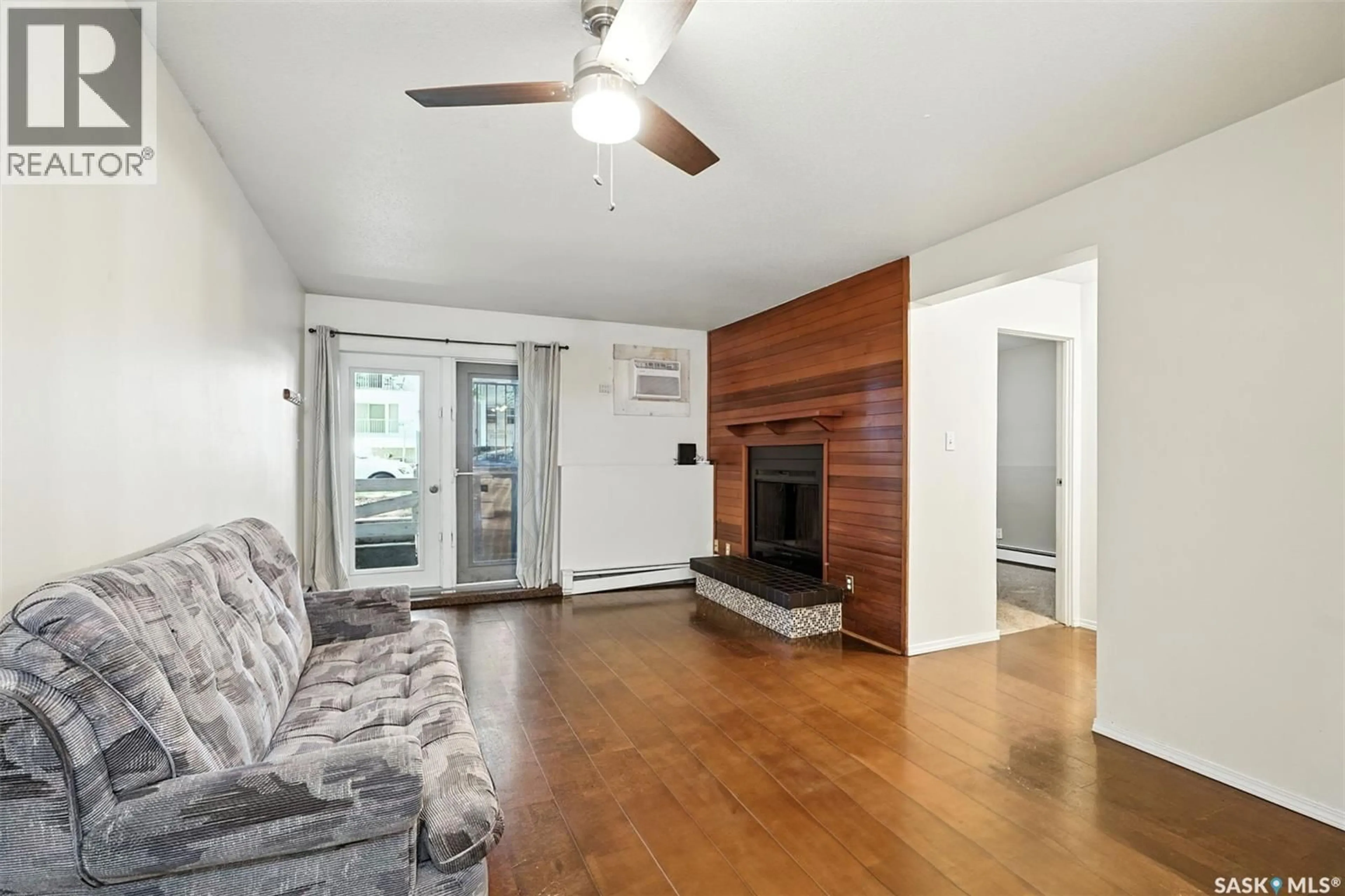 Living room with furniture, wood/laminate floor for 103 - 431 4TH AVENUE, Saskatoon Saskatchewan S7K2M4
