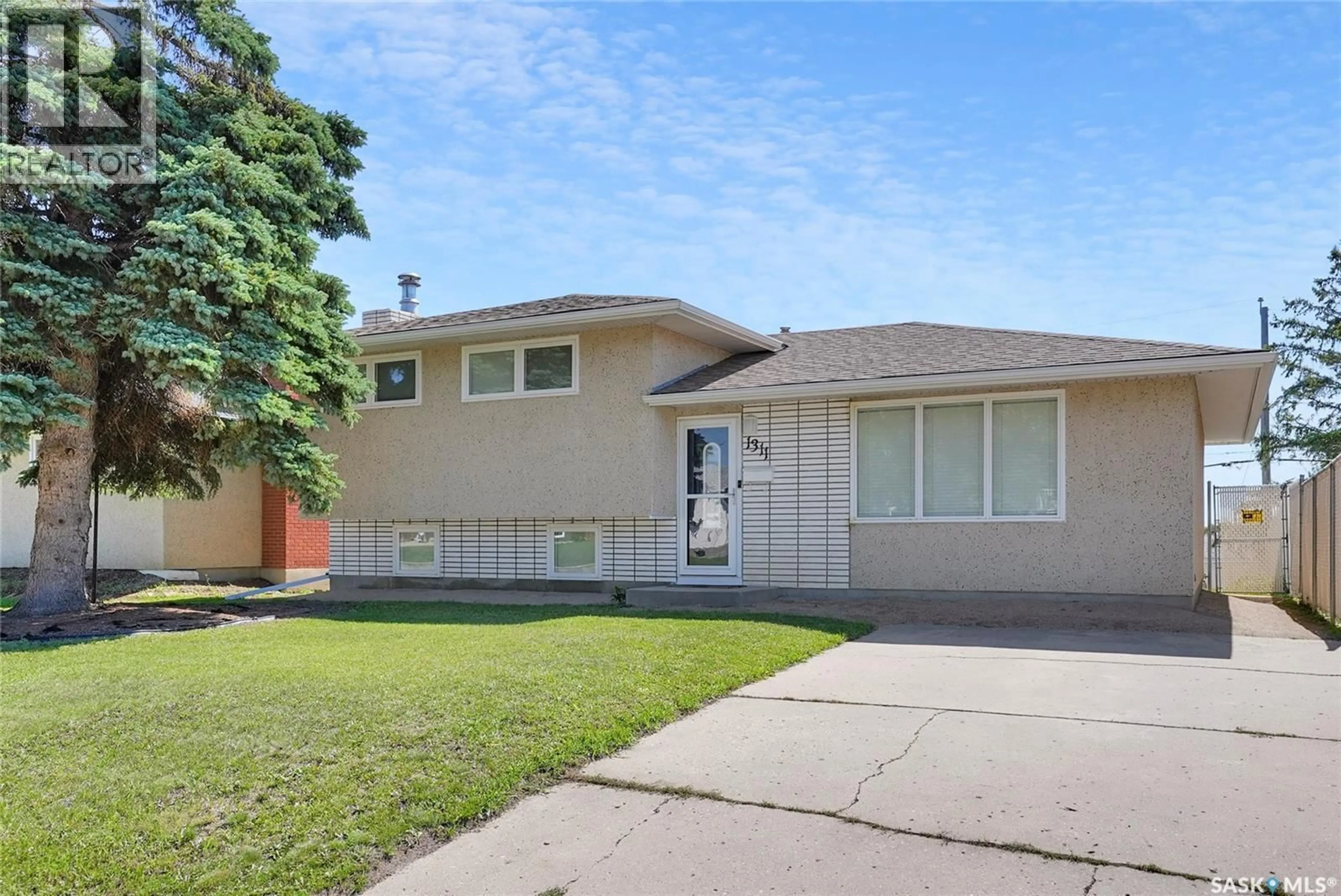 Home with vinyl exterior material, street for 1311 ATHABASCA STREET W, Moose Jaw Saskatchewan S6H6C8