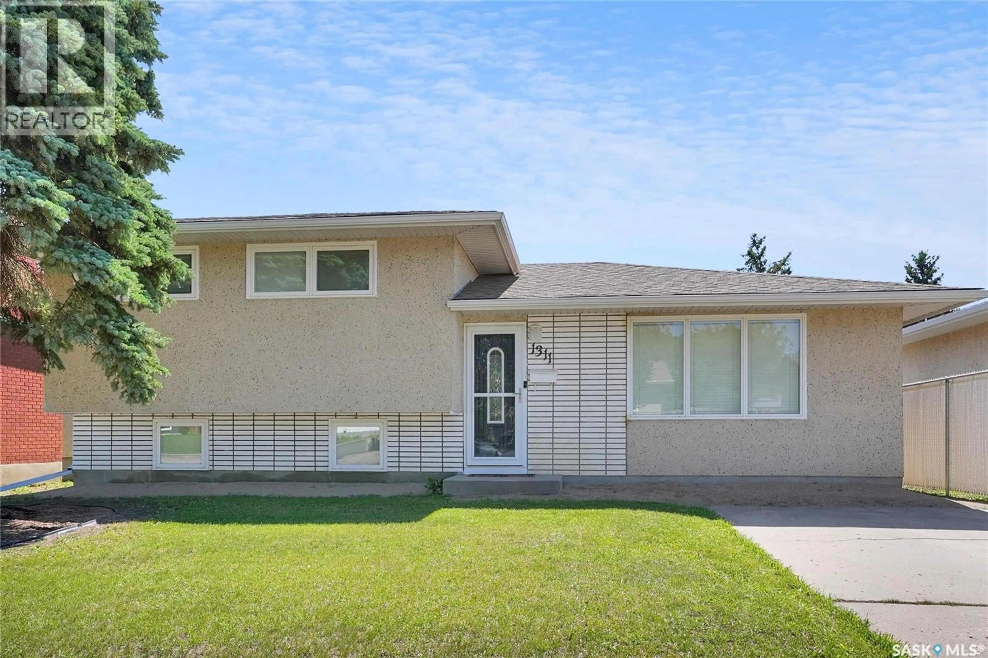 Home with vinyl exterior material, street for 1311 ATHABASCA STREET W, Moose Jaw Saskatchewan S6H6C8