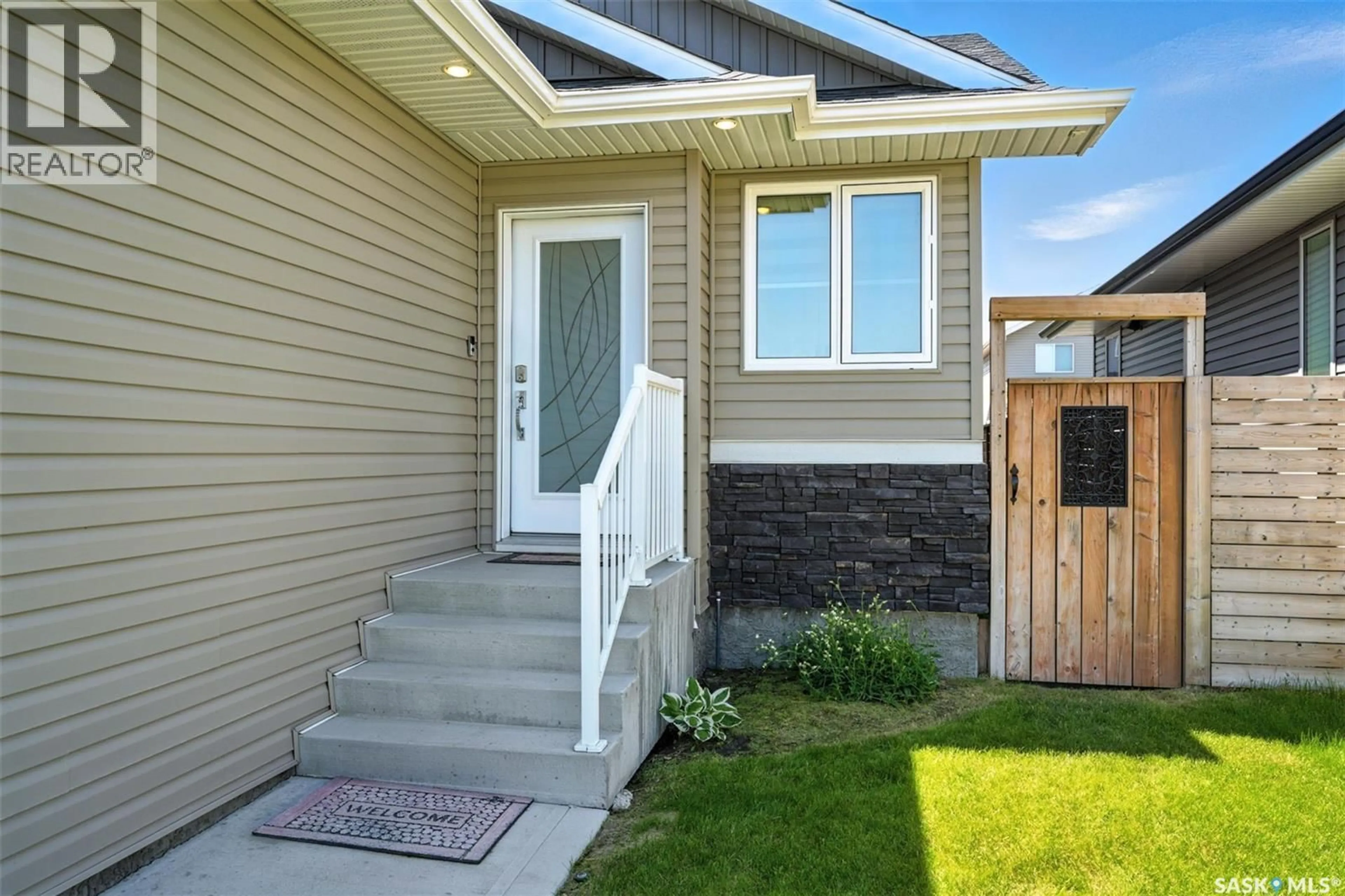 Home with vinyl exterior material, street for 246 HASSARD CLOSE, Saskatoon Saskatchewan S7L4Z7