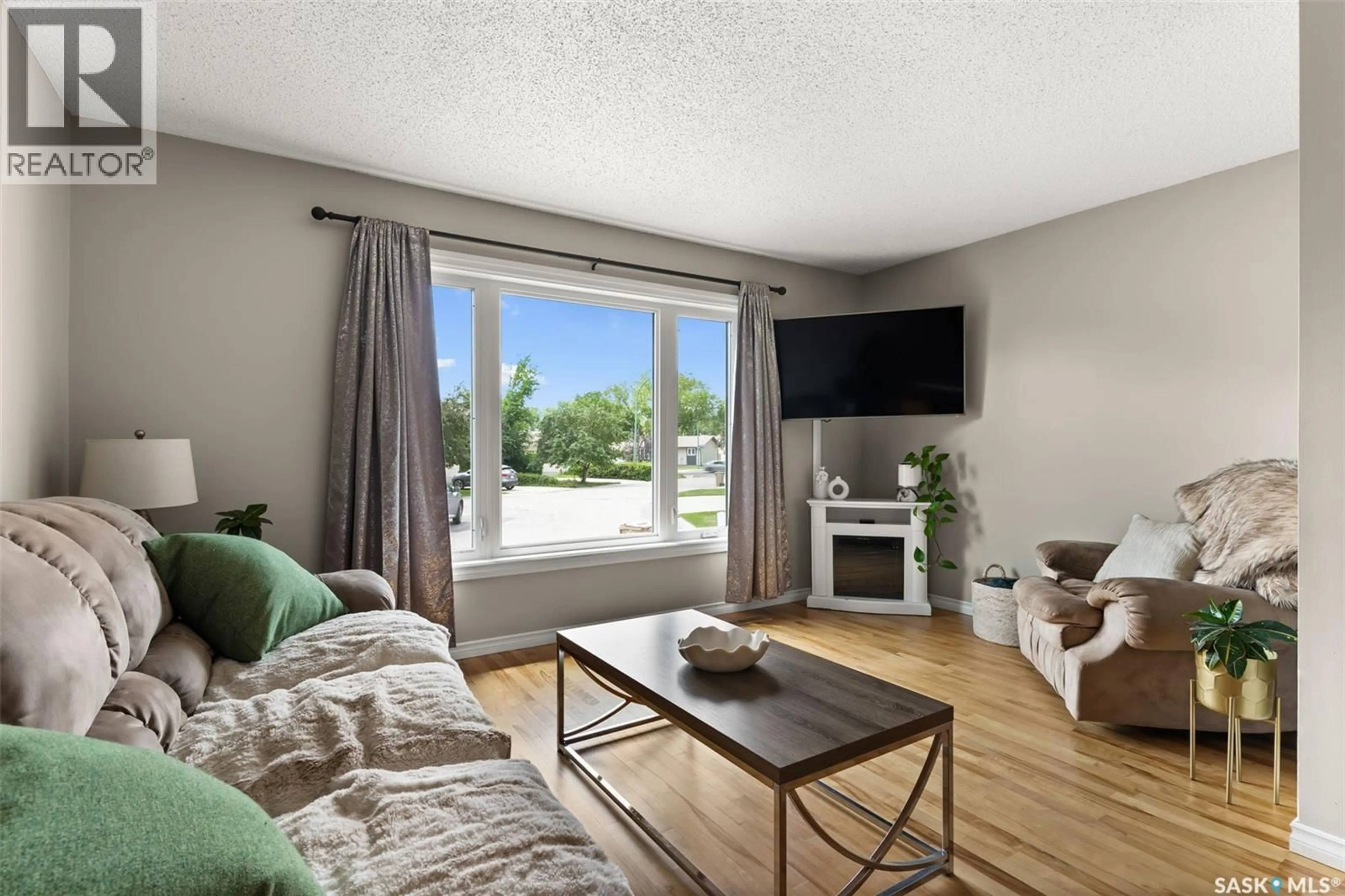 Living room with furniture, wood/laminate floor for 6335 COHEN BAY, Regina Saskatchewan S4X2H5
