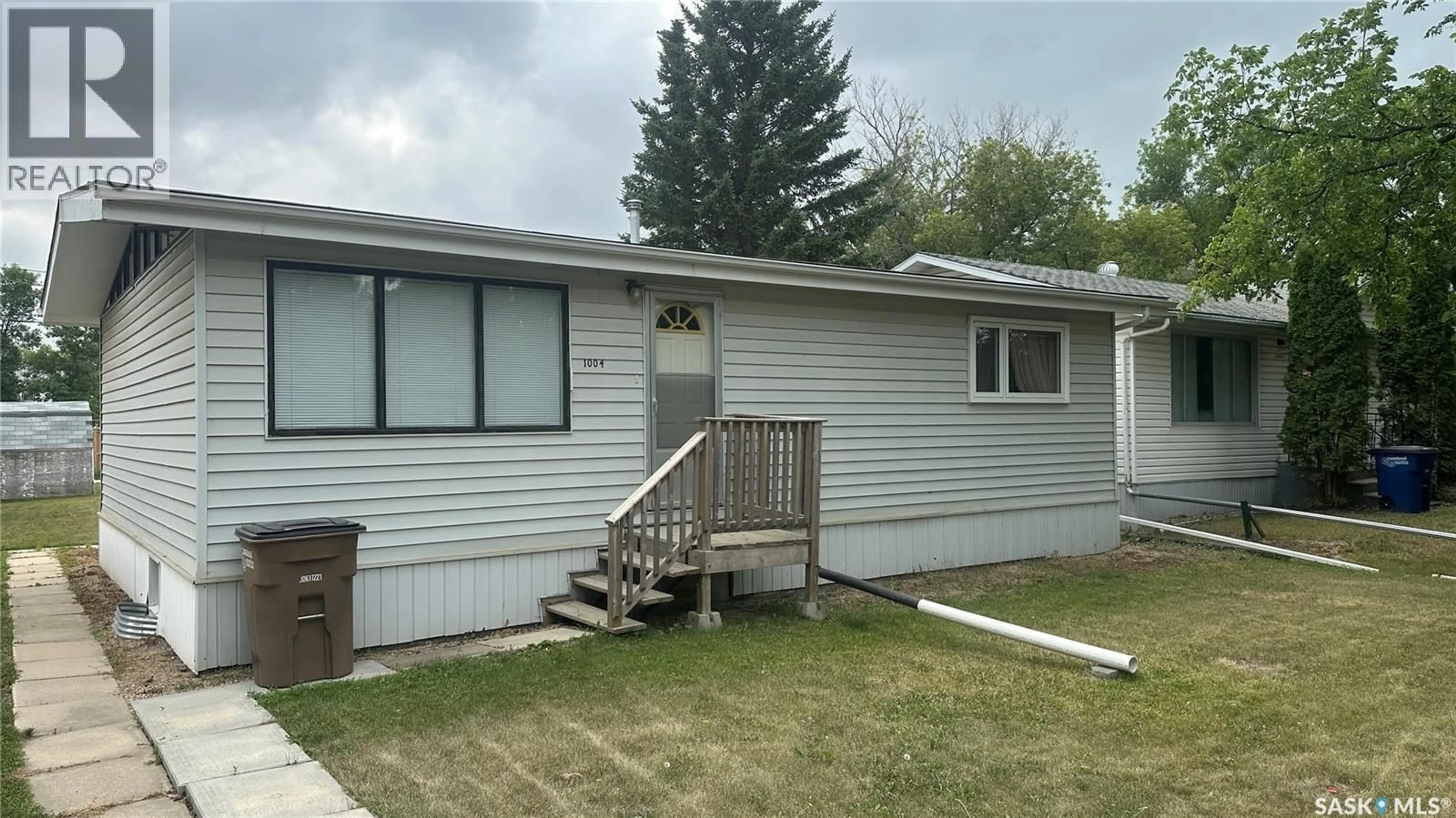 Home with vinyl exterior material, street for 1004 96TH AVENUE, Tisdale Saskatchewan S0E1T0