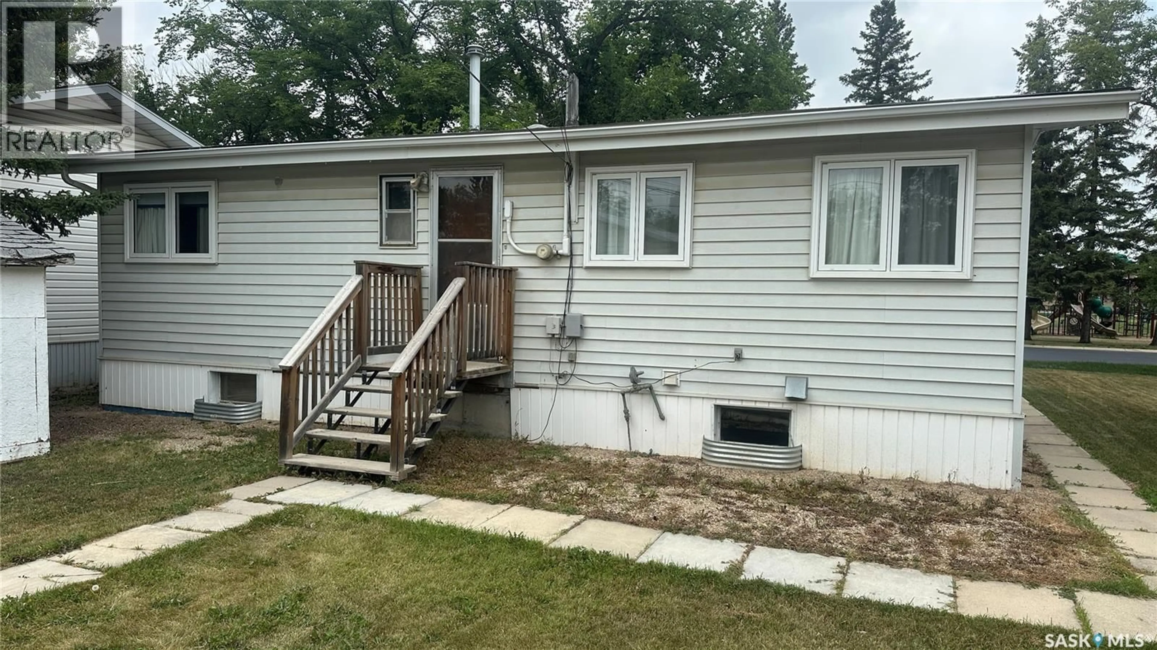 Home with vinyl exterior material, street for 1004 96TH AVENUE, Tisdale Saskatchewan S0E1T0