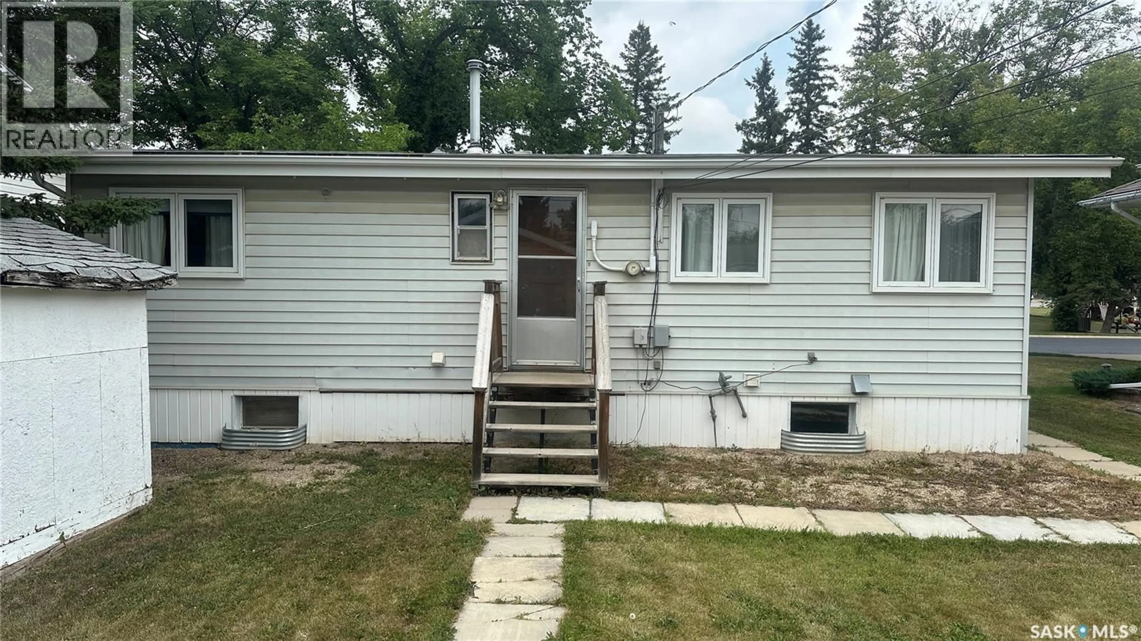 Home with vinyl exterior material, street for 1004 96TH AVENUE, Tisdale Saskatchewan S0E1T0