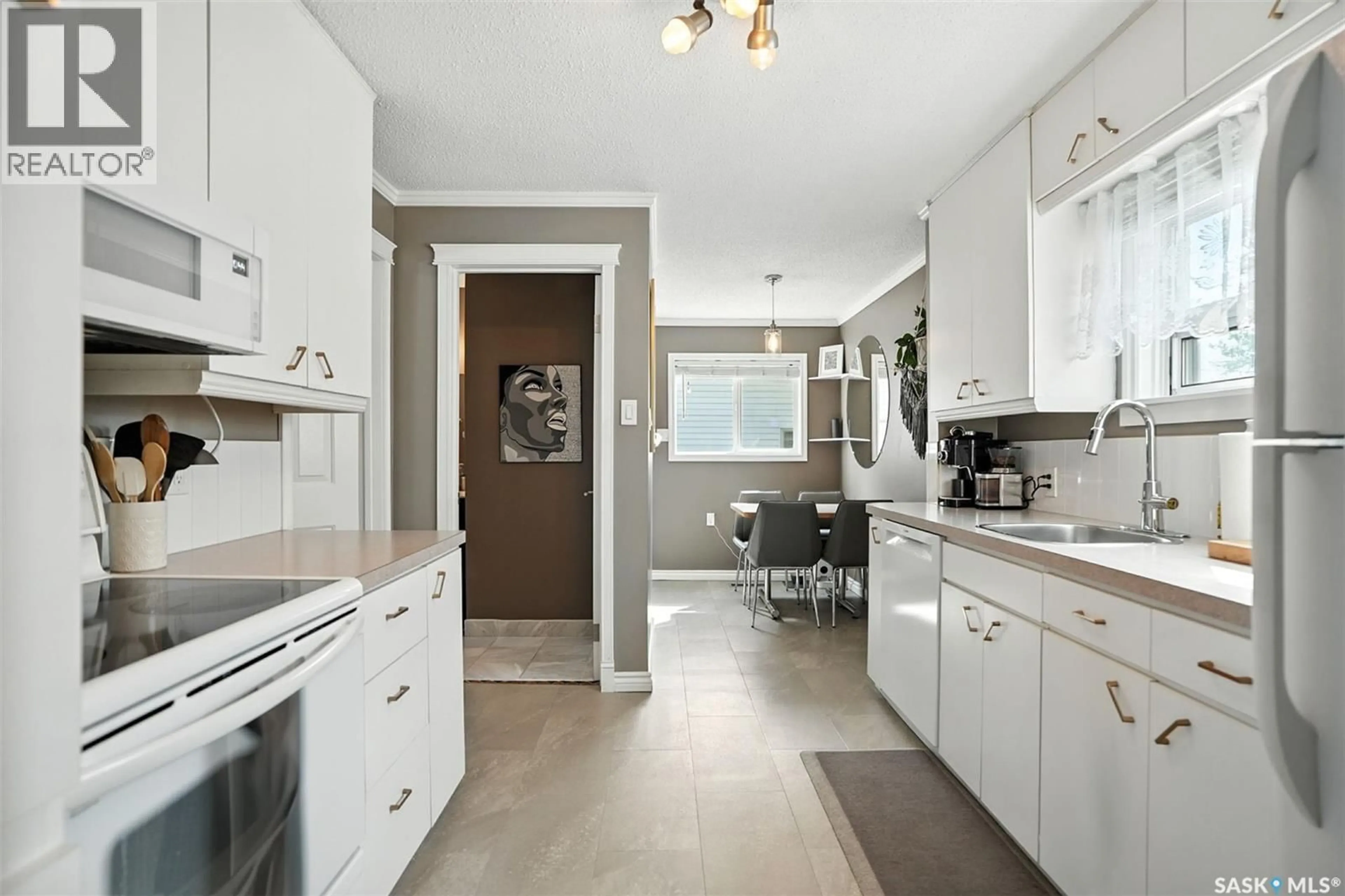 Open concept kitchen, ceramic/tile floor for 2419 MCPHERSON AVENUE, Saskatoon Saskatchewan S7J0T1
