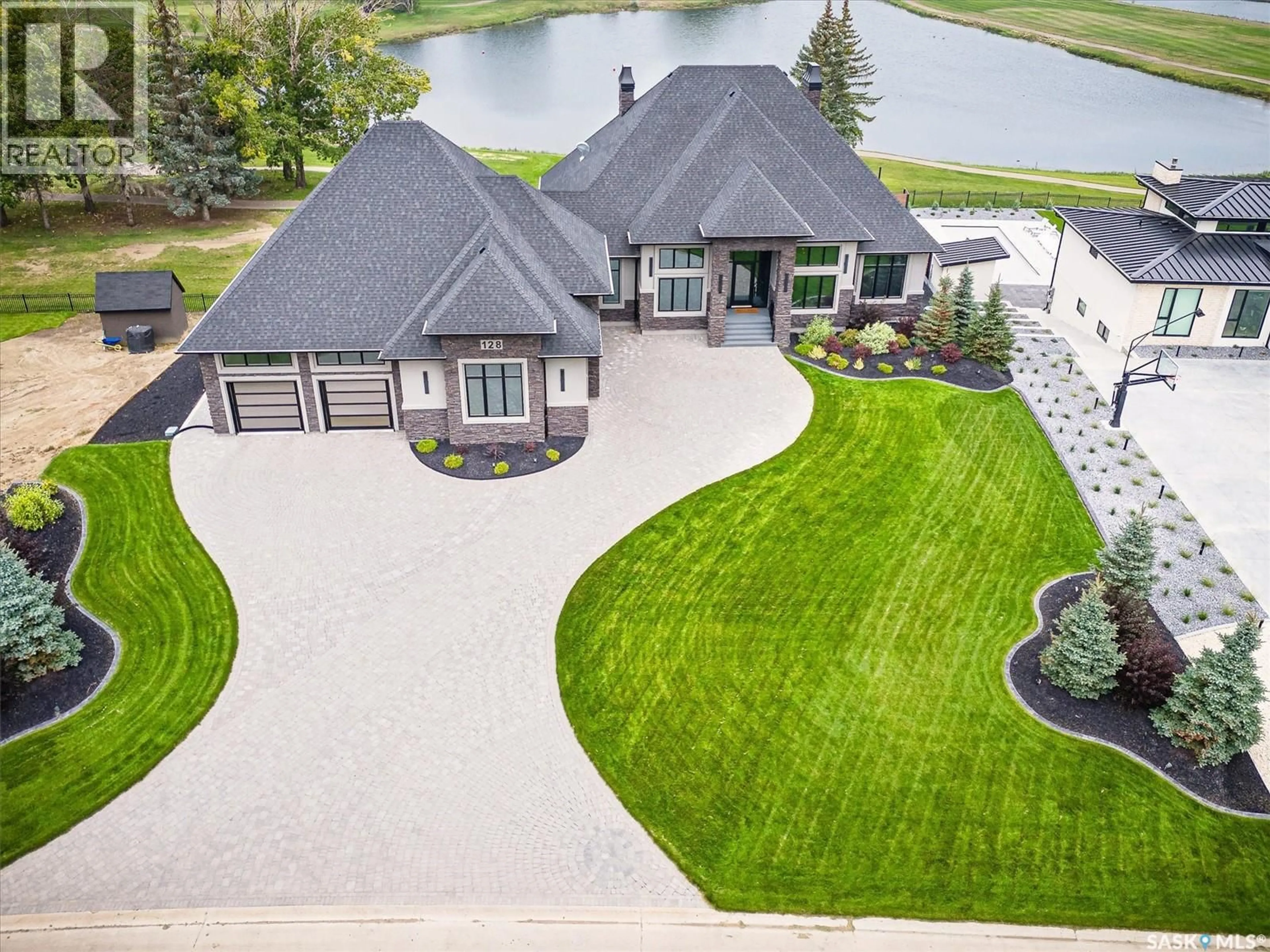 A pic from outside/outdoor area/front of a property/back of a property/a pic from drone, water/lake/river/ocean view for 128 GREENBRYRE CRESCENT, Corman Park Rm No. 344 Saskatchewan S7V0J5