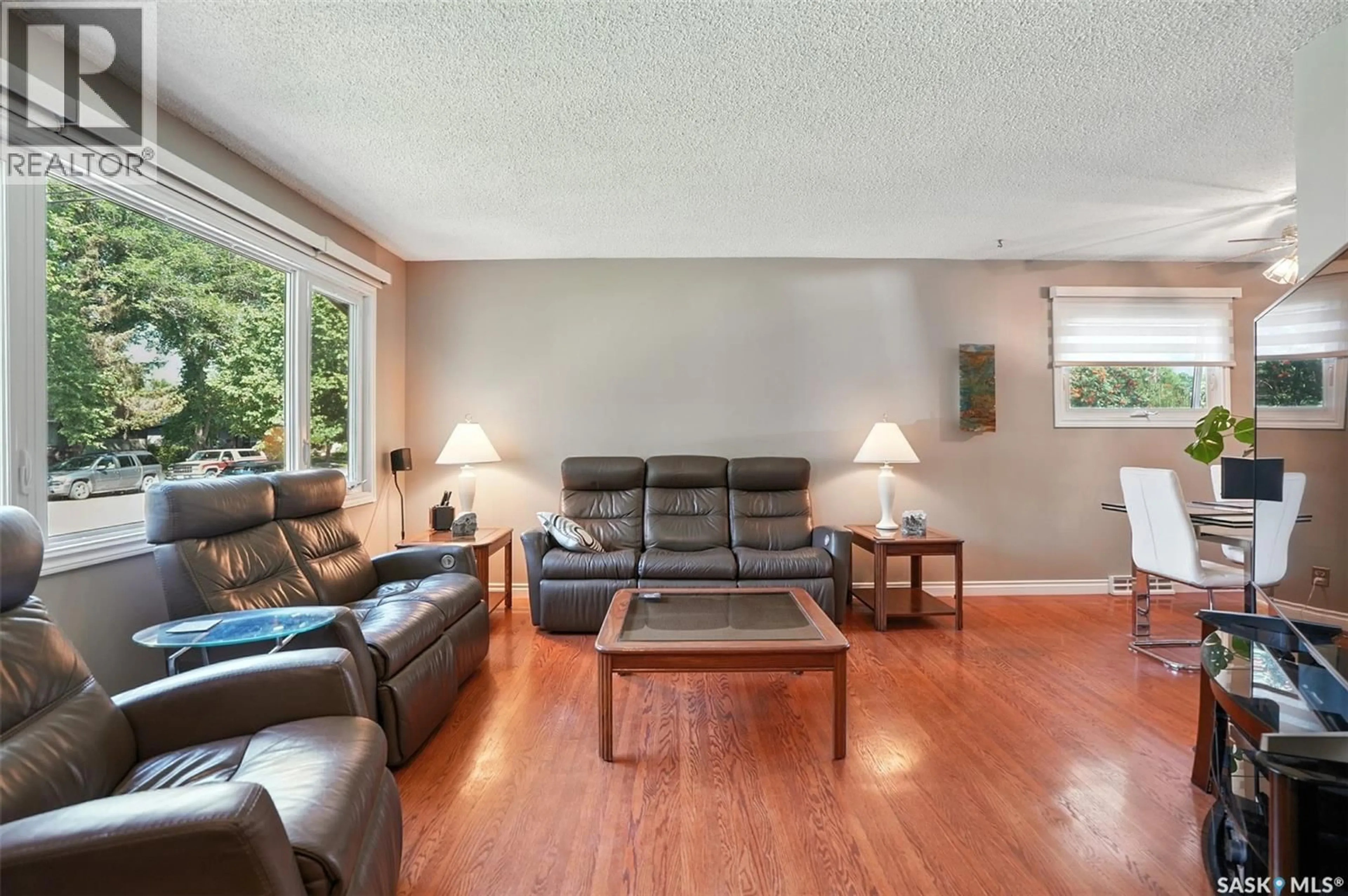 Living room with furniture, wood/laminate floor for 22 CANTLON CRESCENT, Saskatoon Saskatchewan S7J2T3