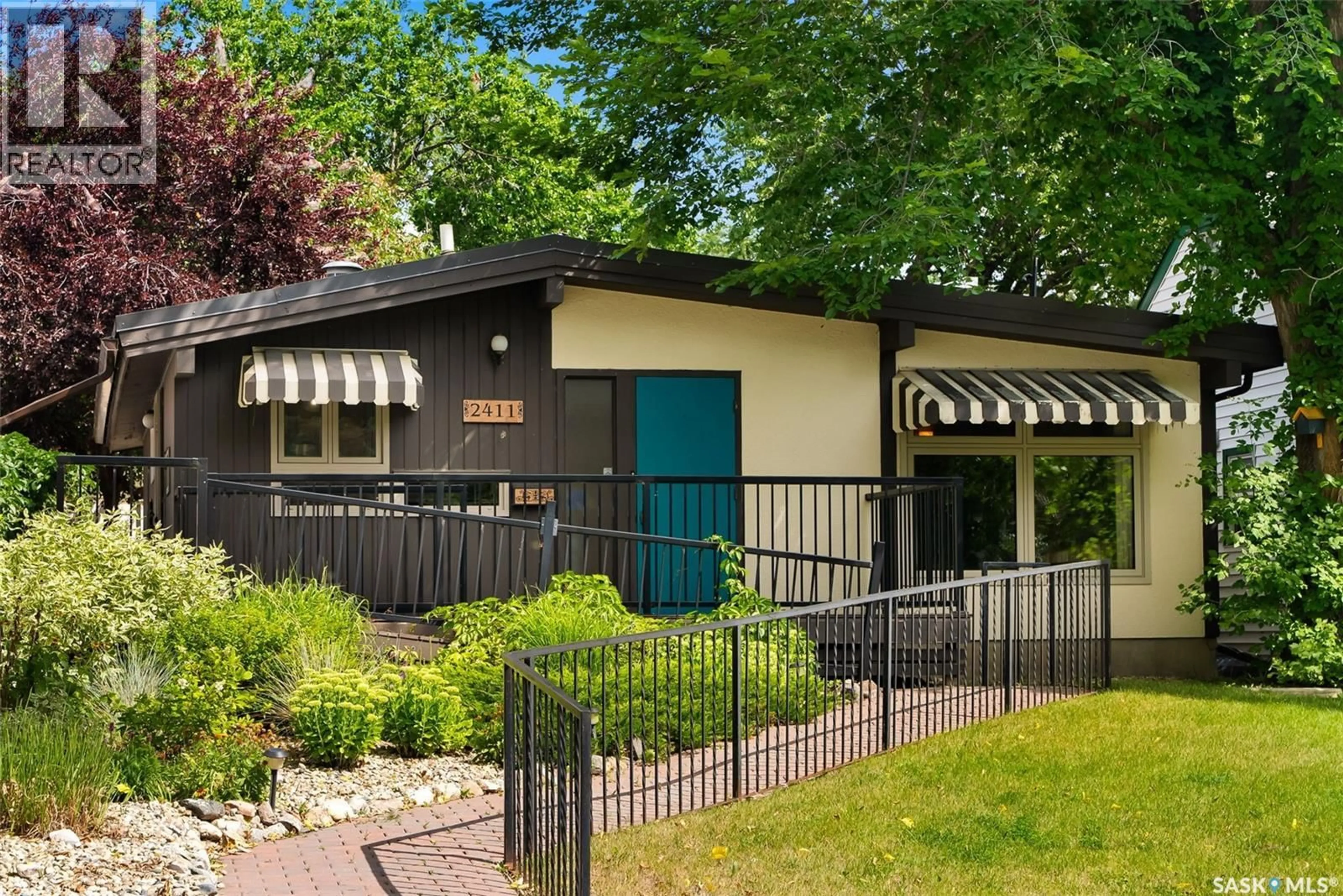 Home with vinyl exterior material, street for 2411 ATHOL STREET, Regina Saskatchewan S4T3G6