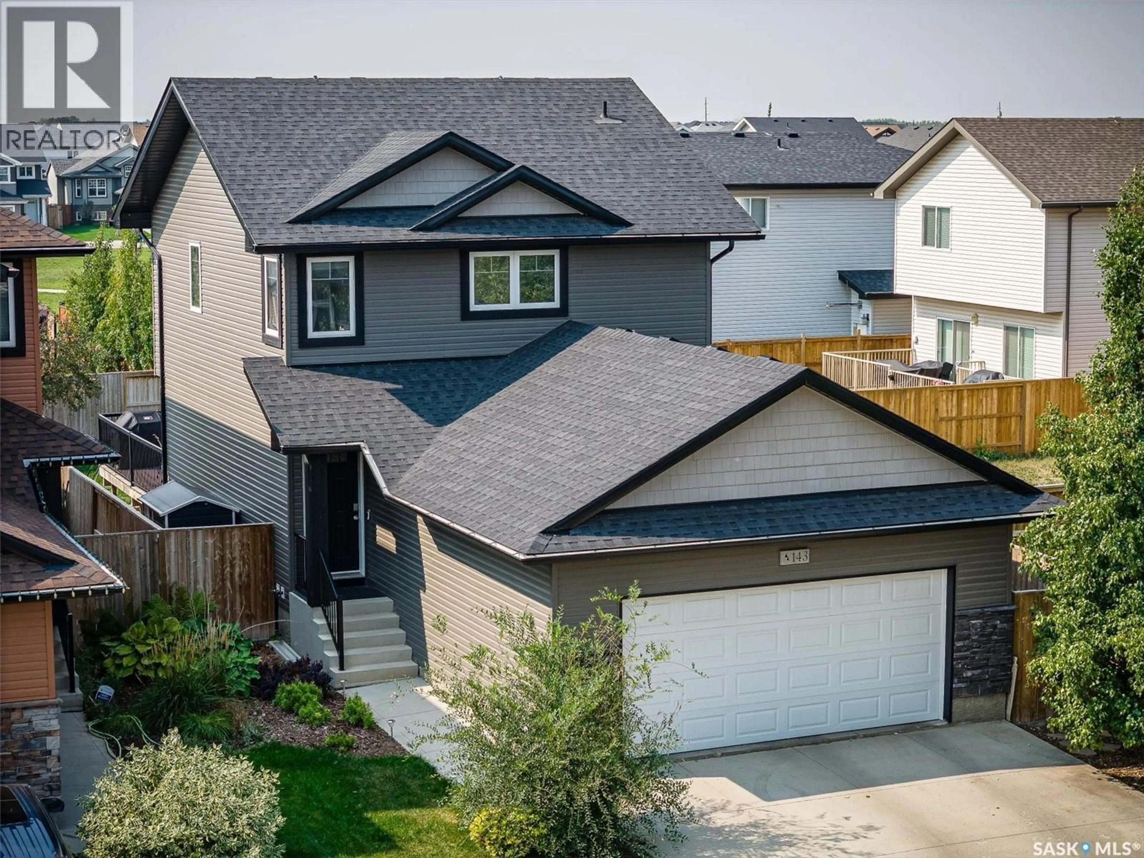 A pic from outside/outdoor area/front of a property/back of a property/a pic from drone, street for 143 CHILDERS CRESCENT, Saskatoon Saskatchewan S7L3G4