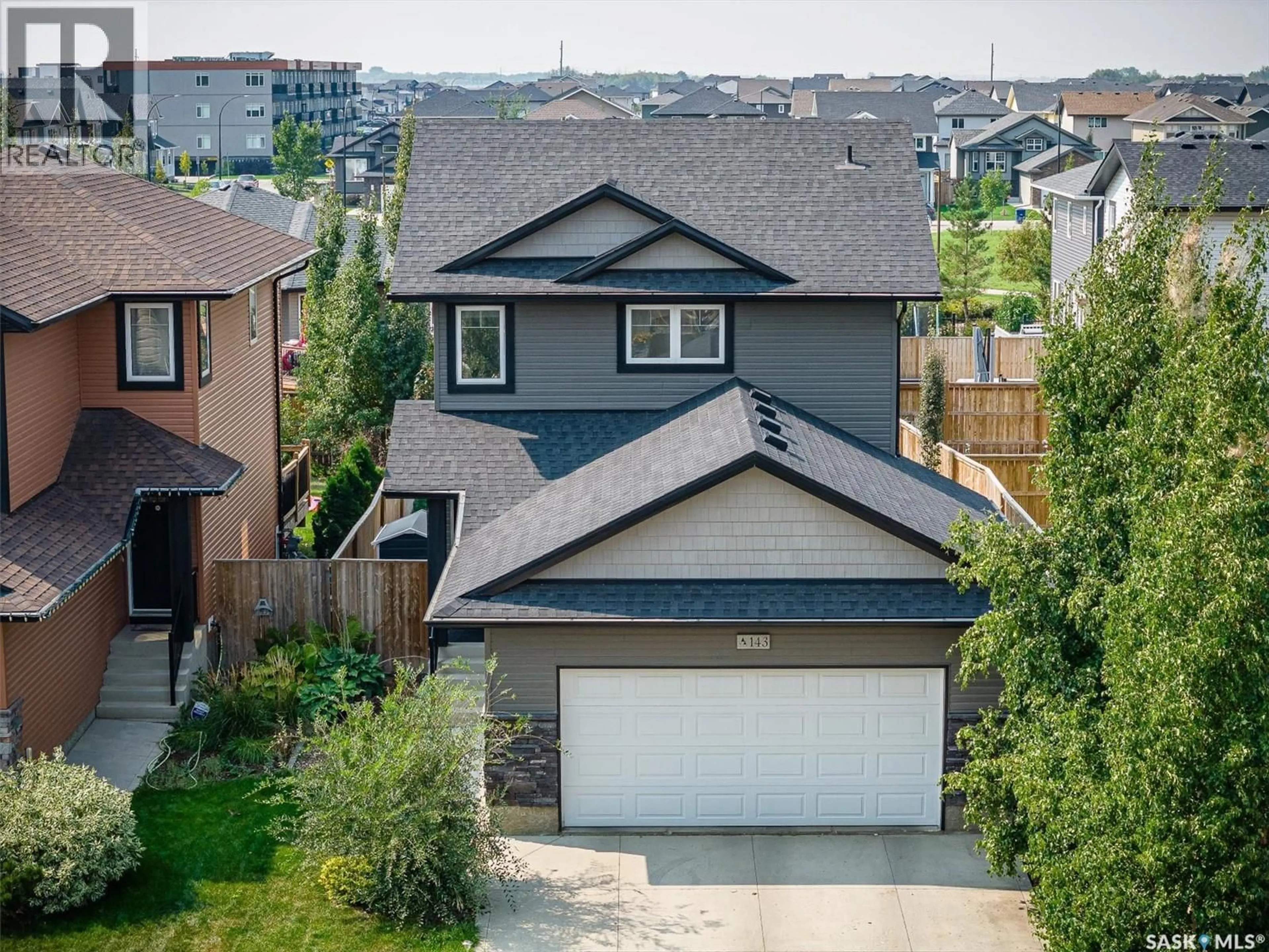 A pic from outside/outdoor area/front of a property/back of a property/a pic from drone, street for 143 CHILDERS CRESCENT, Saskatoon Saskatchewan S7L3G4