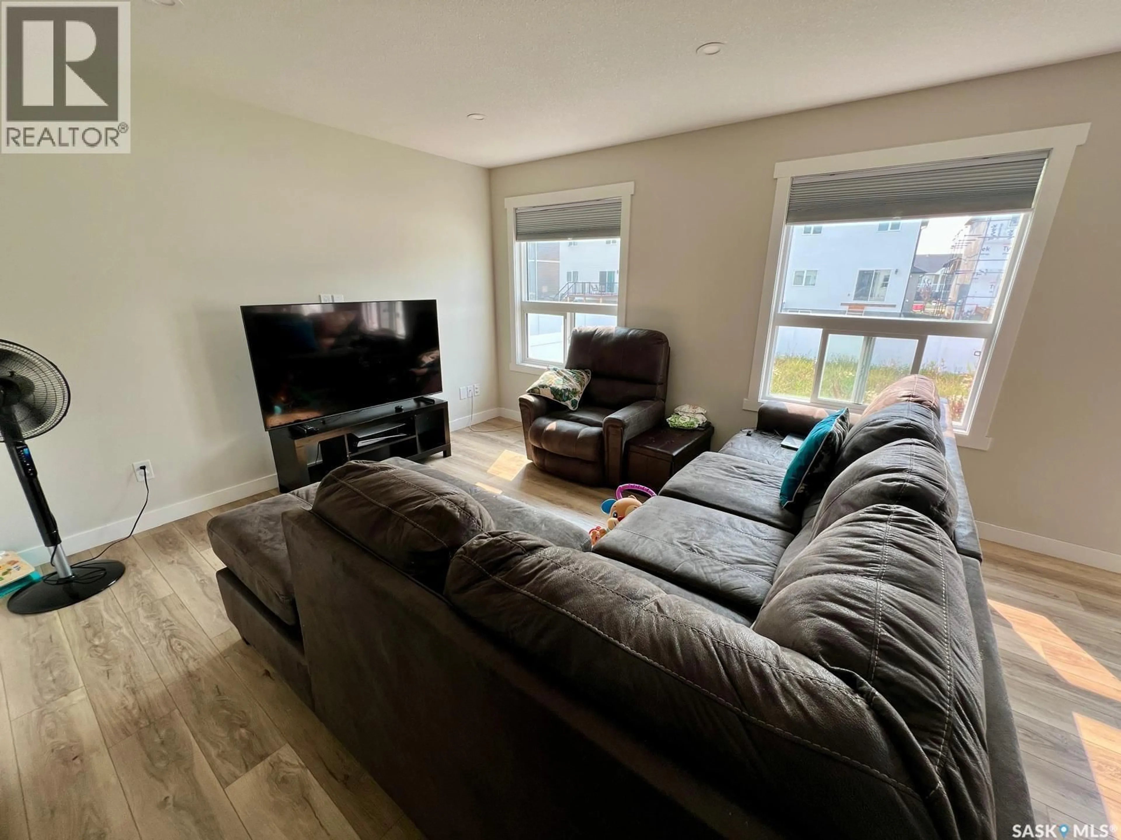 Living room with furniture, wood/laminate floor for 4629 MUTRIE CRESCENT, Regina Saskatchewan S4V3Y3