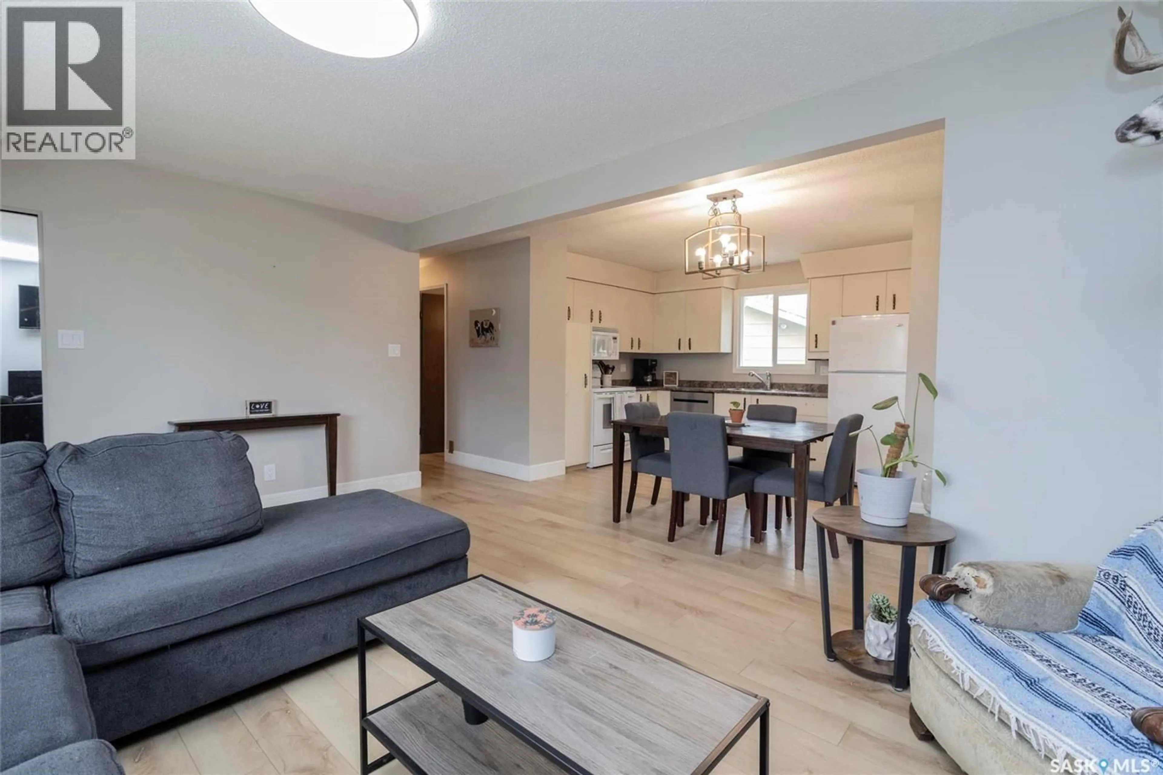Living room with furniture, wood/laminate floor for 823 STEEVES AVENUE, Saskatoon Saskatchewan S7L5N2