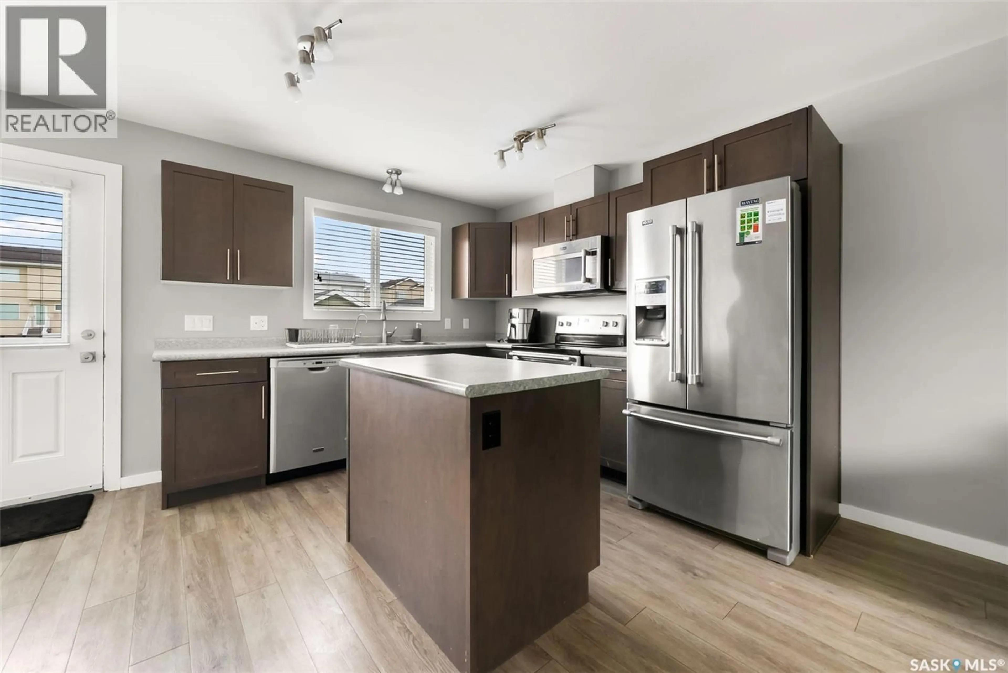 Open concept kitchen, wood/laminate floor for 4638 ALBULET DRIVE, Regina Saskatchewan S4W0R3