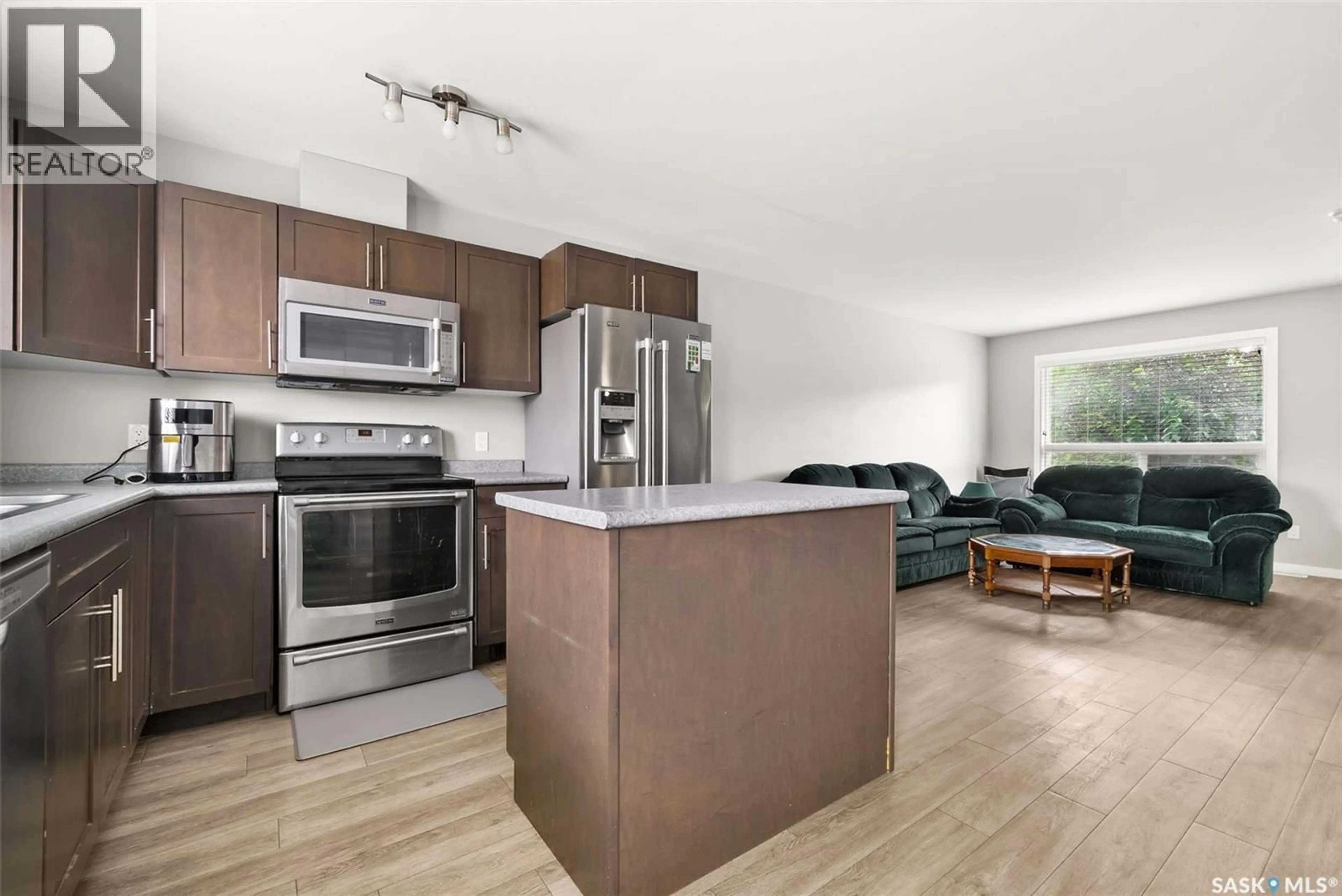 Open concept kitchen, wood/laminate floor for 4638 ALBULET DRIVE, Regina Saskatchewan S4W0R3
