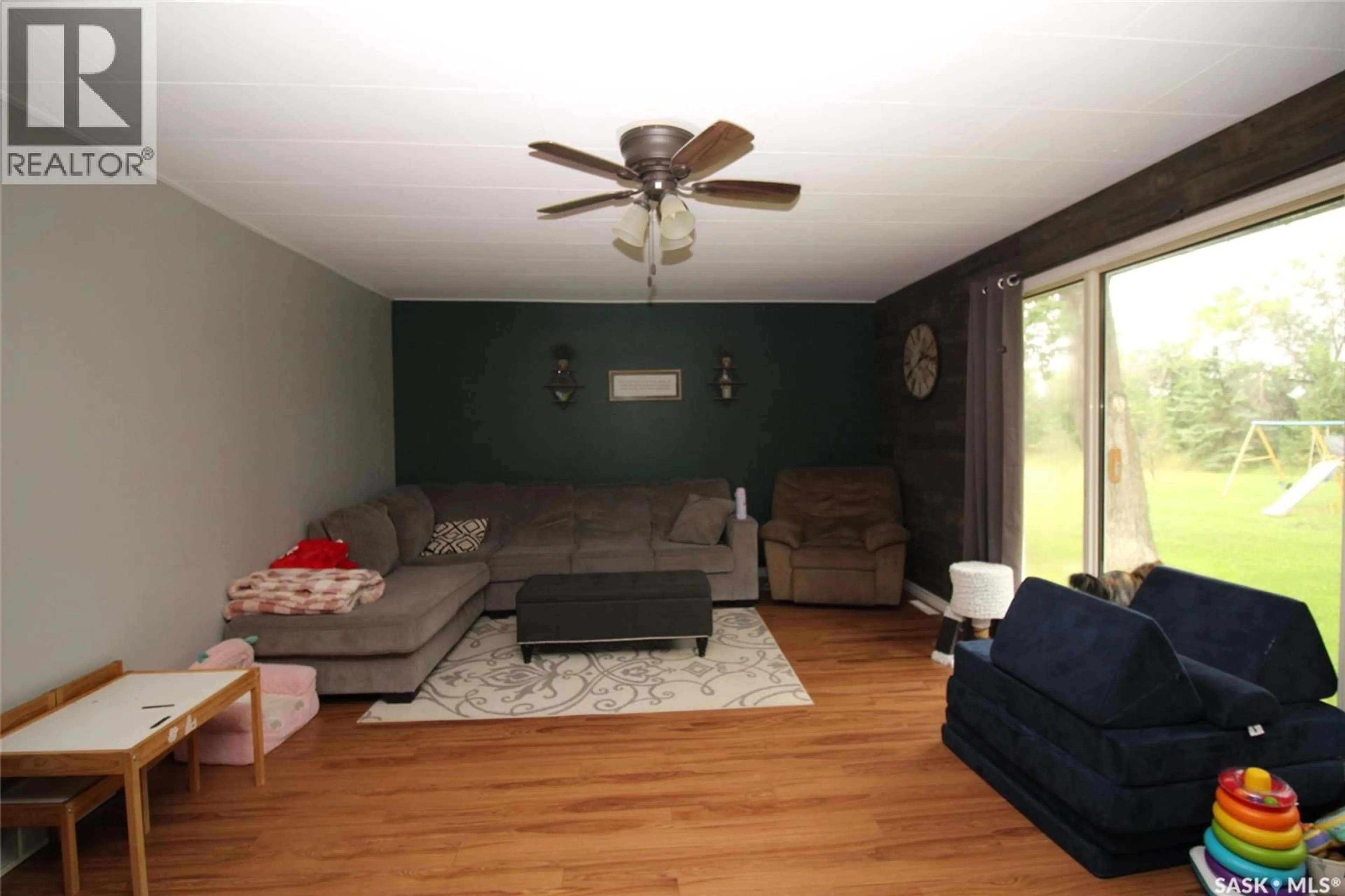Living room with furniture, wood/laminate floor for 34 NE 34-05 W3, White Valley Rm No. 49 Saskatchewan S0N0T0