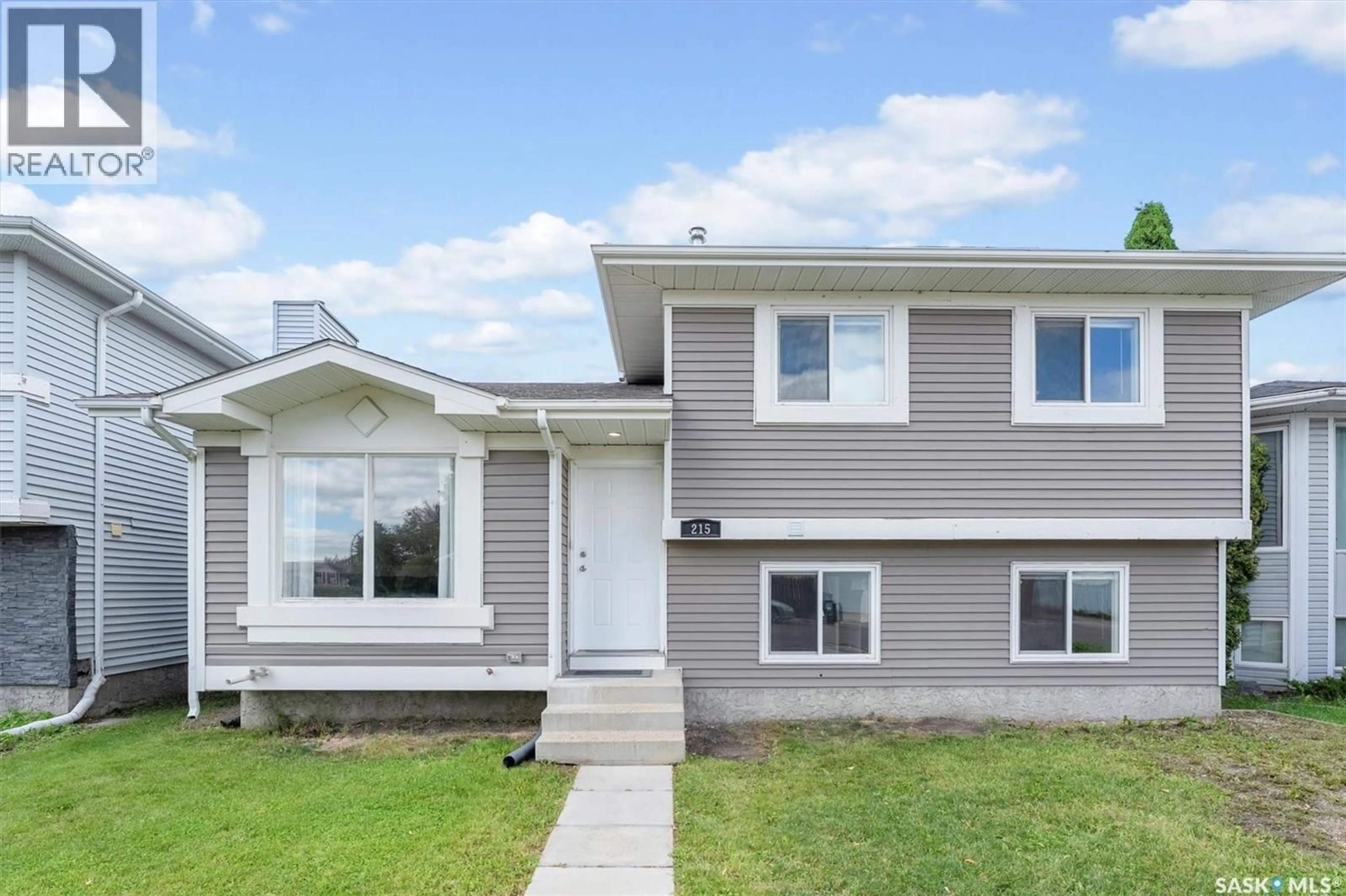 Home with vinyl exterior material, street for 215 CARTER CRESCENT, Saskatoon Saskatchewan S7L7K4