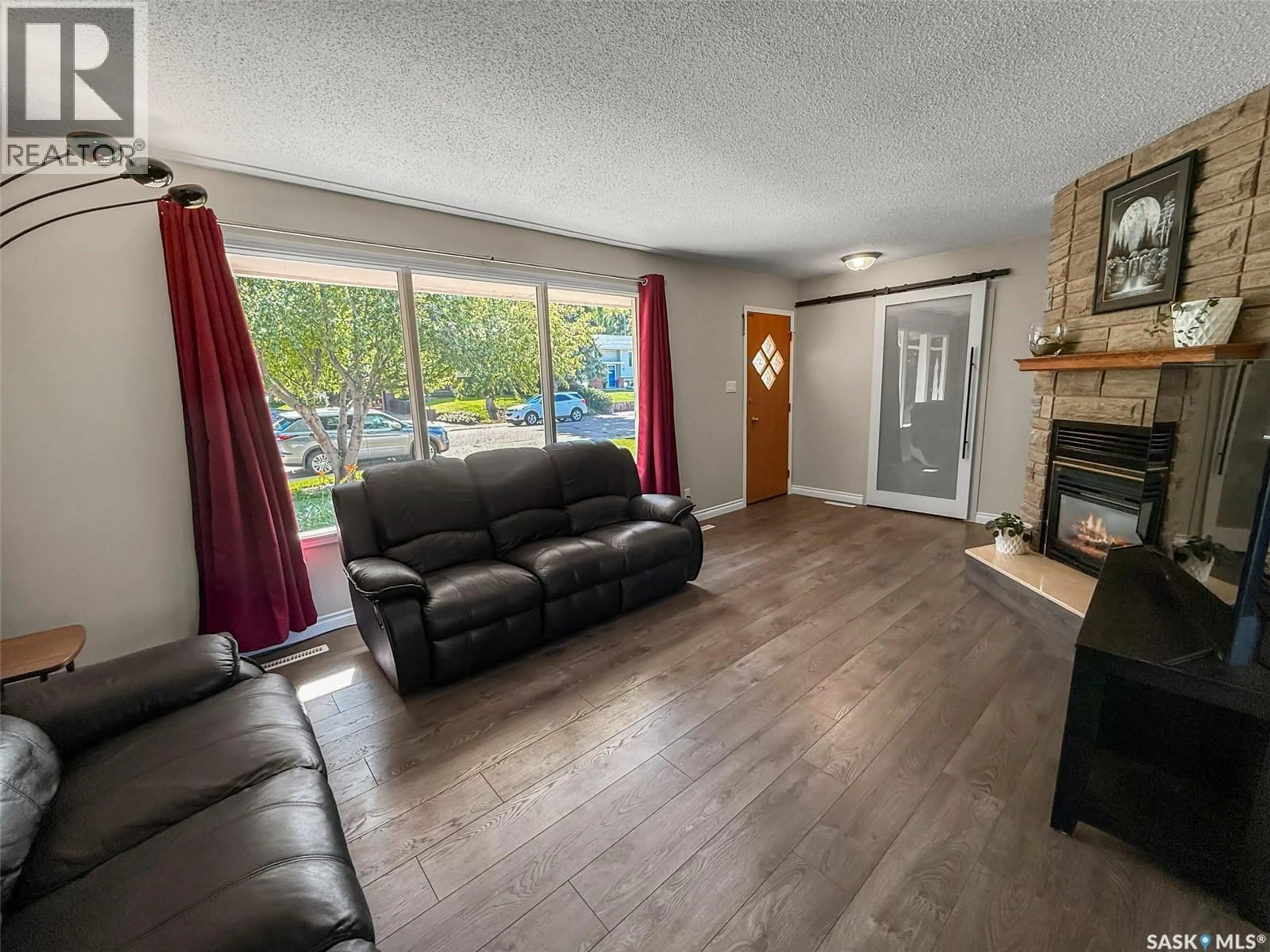 Living room with furniture, wood/laminate floor for 343 ALDER PLACE, Swift Current Saskatchewan S9H3E5