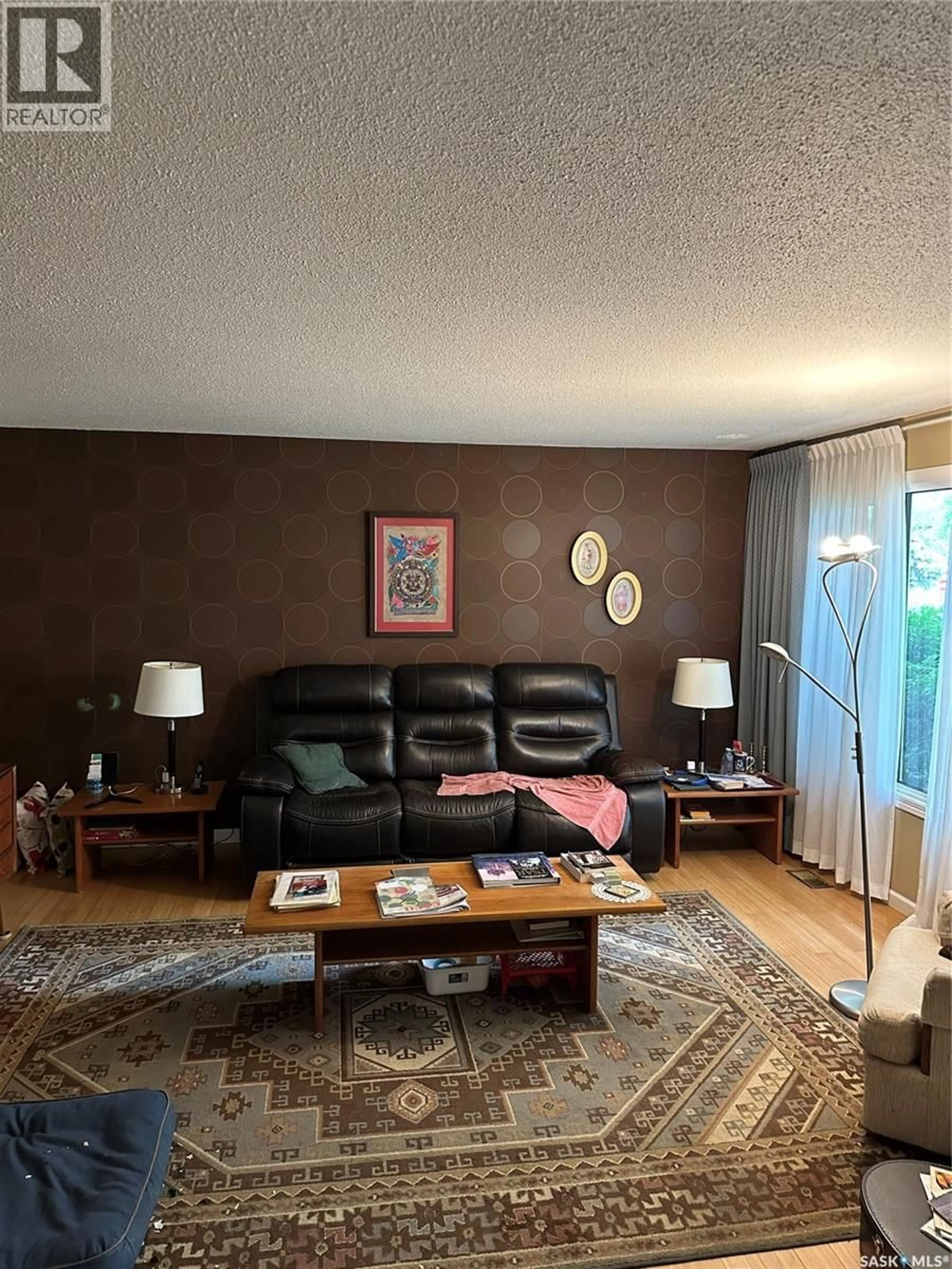 Living room with furniture, wood/laminate floor for 1806 EASTHILL, Saskatoon Saskatchewan S7J3C1