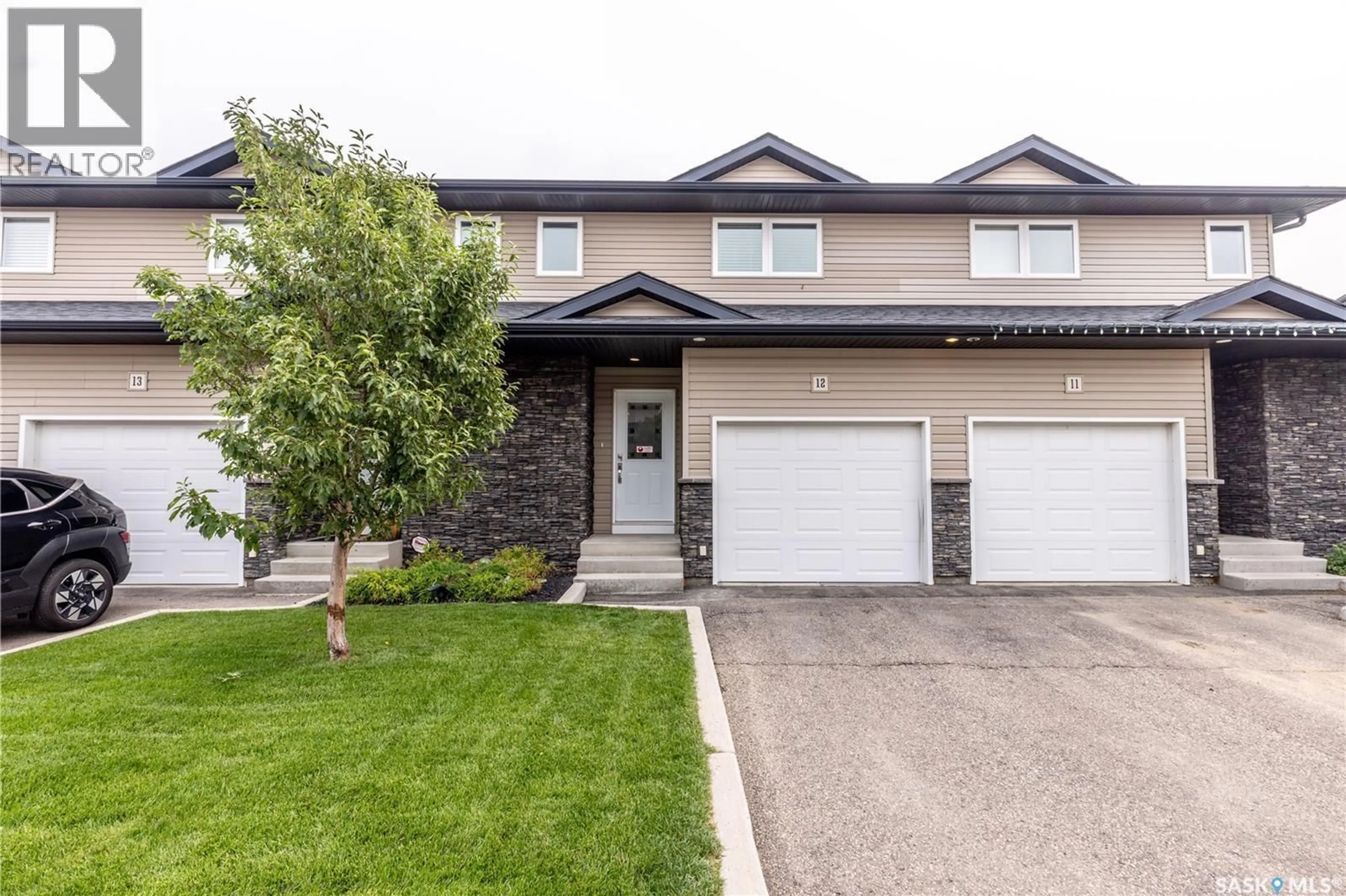Home with vinyl exterior material, street for 12 365 DAWSON CRESCENT, Saskatoon Saskatchewan S7R0L6