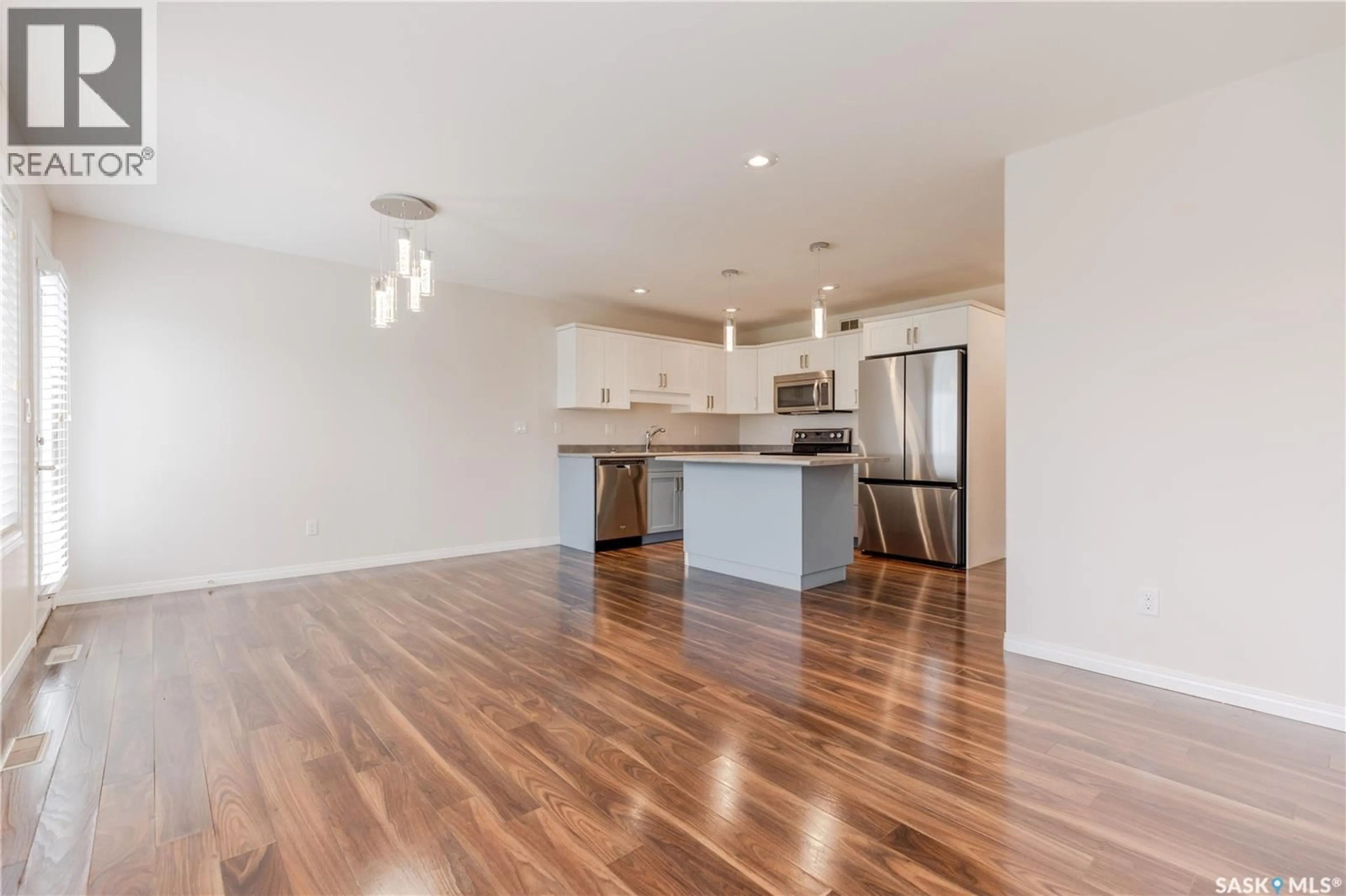 Open concept kitchen, wood/laminate floor for 12 365 DAWSON CRESCENT, Saskatoon Saskatchewan S7R0L6
