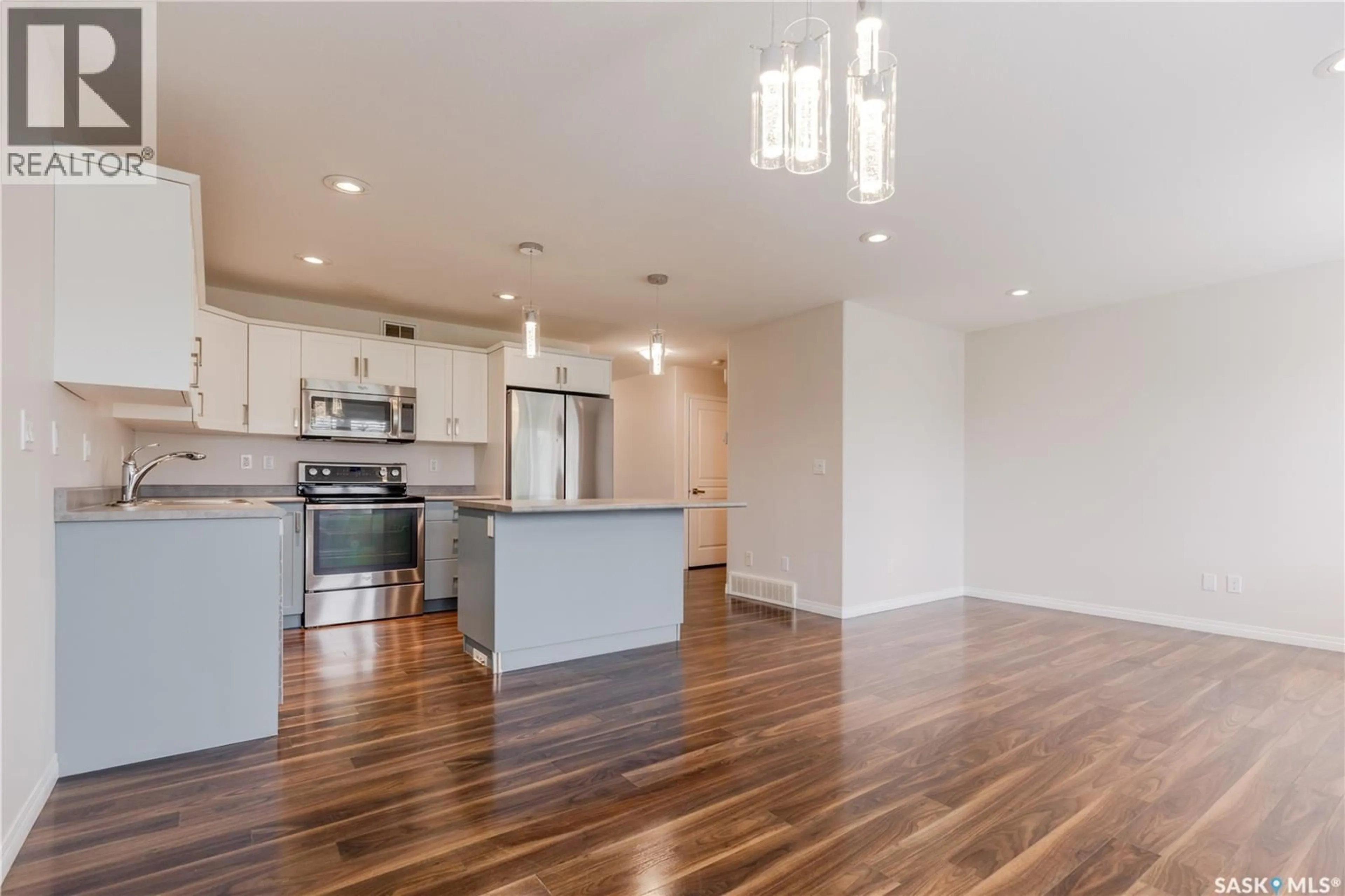 Open concept kitchen, wood/laminate floor for 12 365 DAWSON CRESCENT, Saskatoon Saskatchewan S7R0L6
