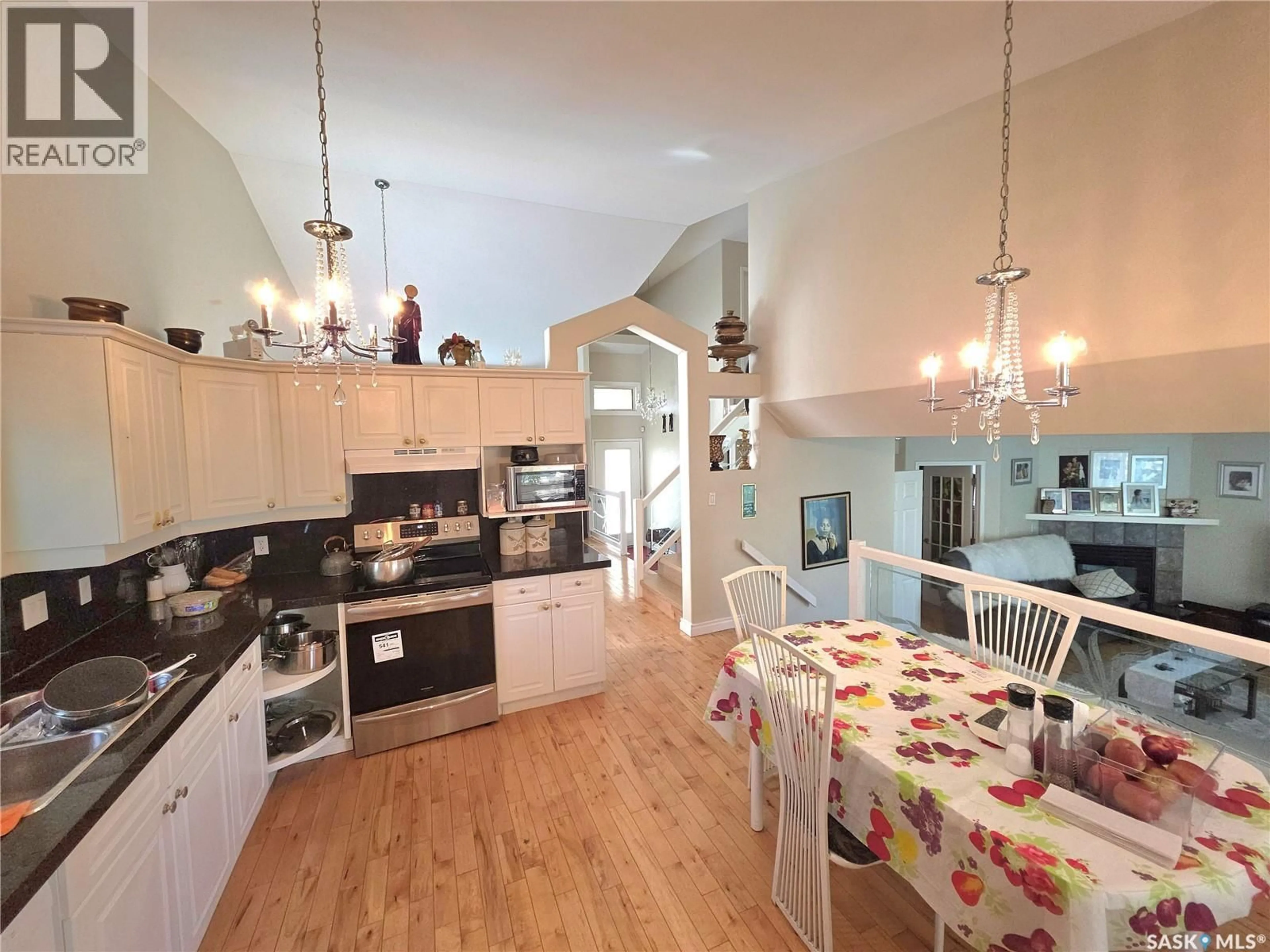 Open concept kitchen, wood/laminate floor for 306 BLACKTHORN CRESCENT, Saskatoon Saskatchewan S7V1B1