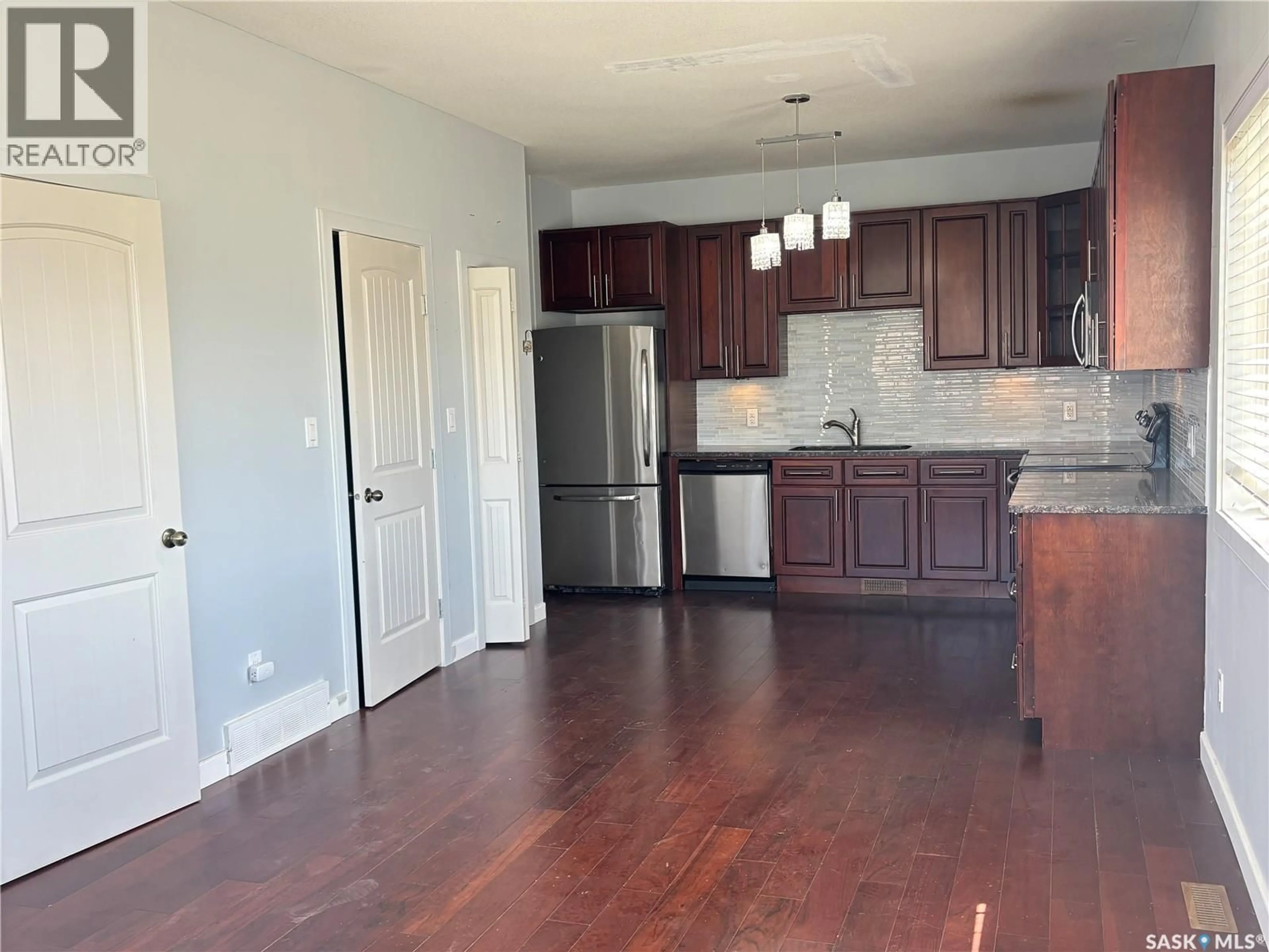 Open concept kitchen, wood/laminate floor for 8 - 1703 PATRICK CRESCENT, Saskatoon Saskatchewan S7W0G1