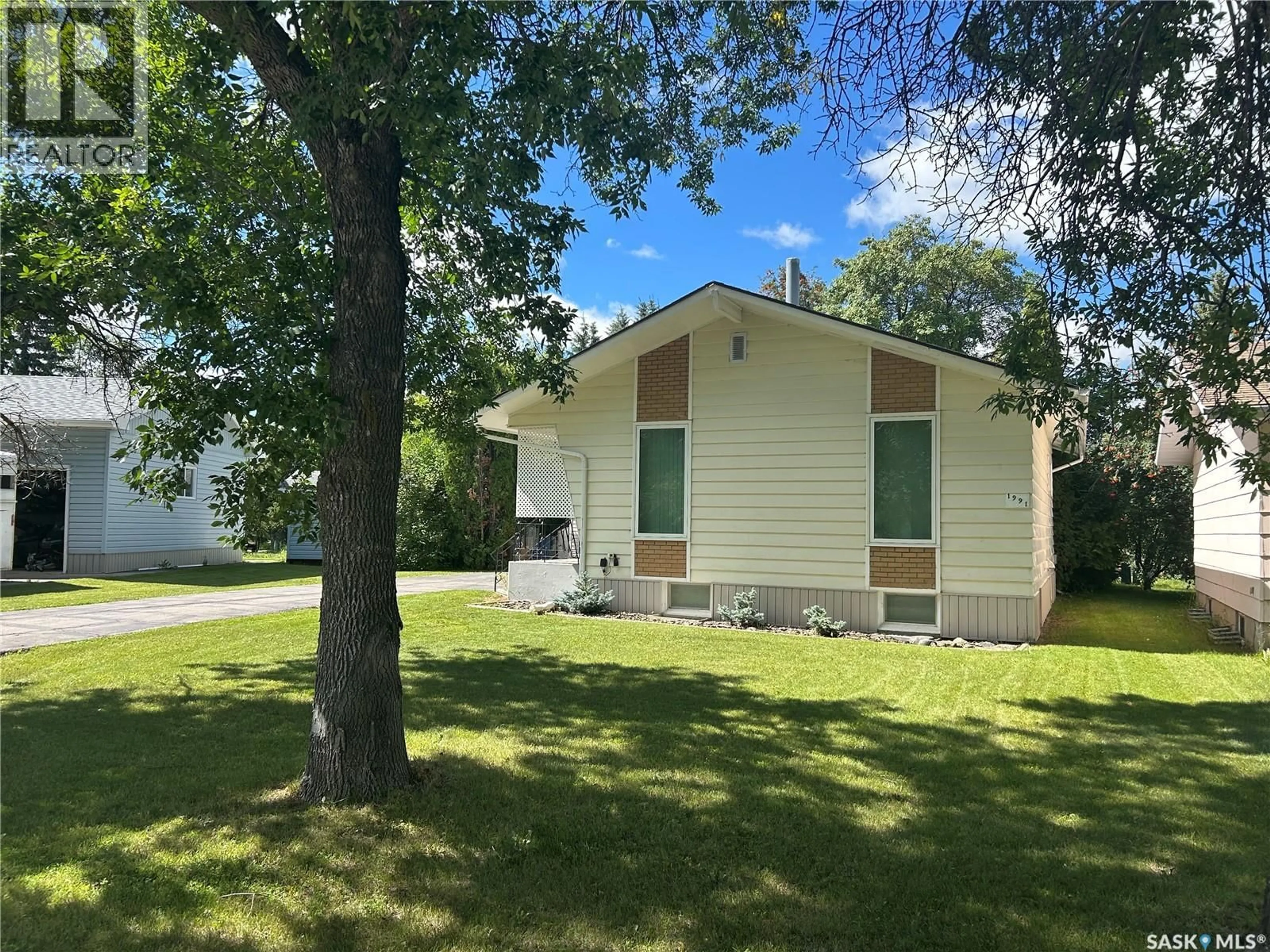 Home with vinyl exterior material, street for 1991 NEWMARKET DRIVE, Tisdale Saskatchewan S0E1T0