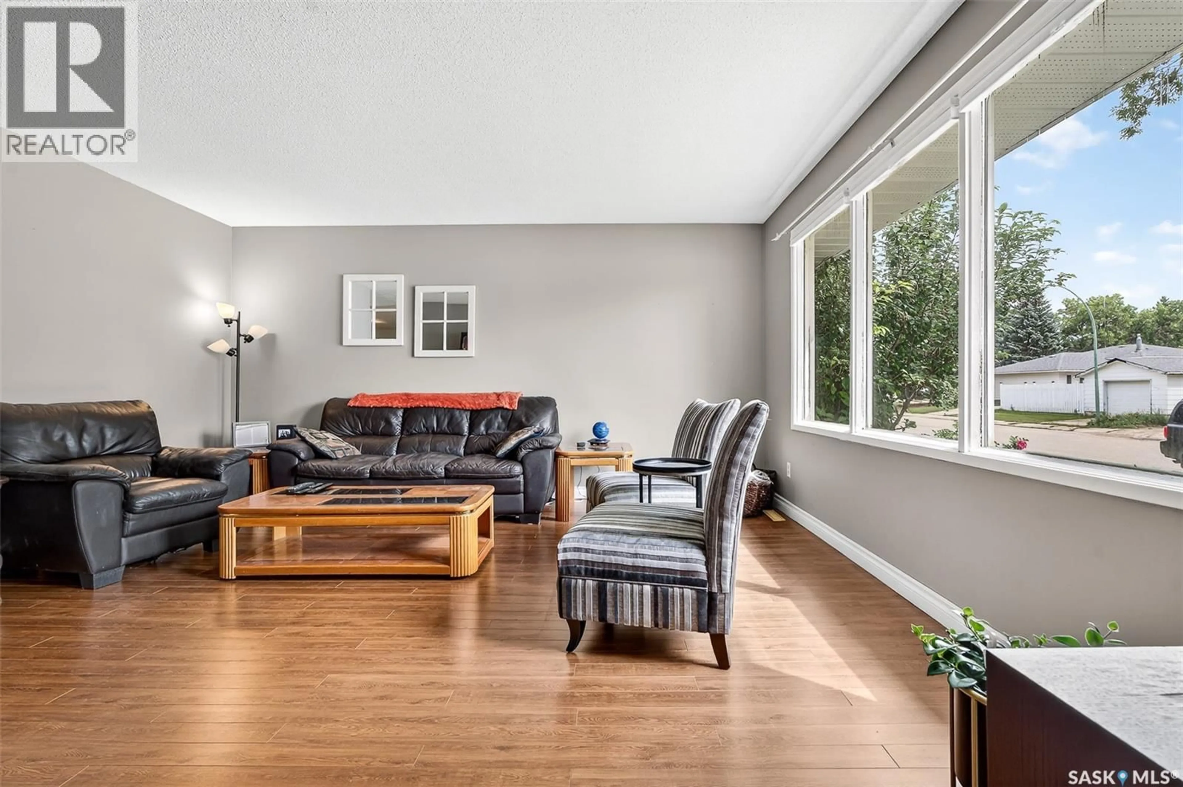 Living room with furniture, wood/laminate floor for 1345 QUEEN CRESCENT, Moose Jaw Saskatchewan S6H3G5